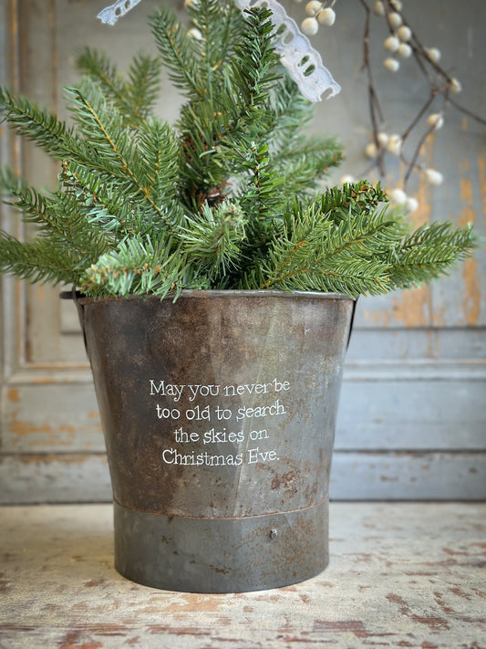 A Recycled Metal Small Christmas Tree Bucket With A Hand Painted Quote