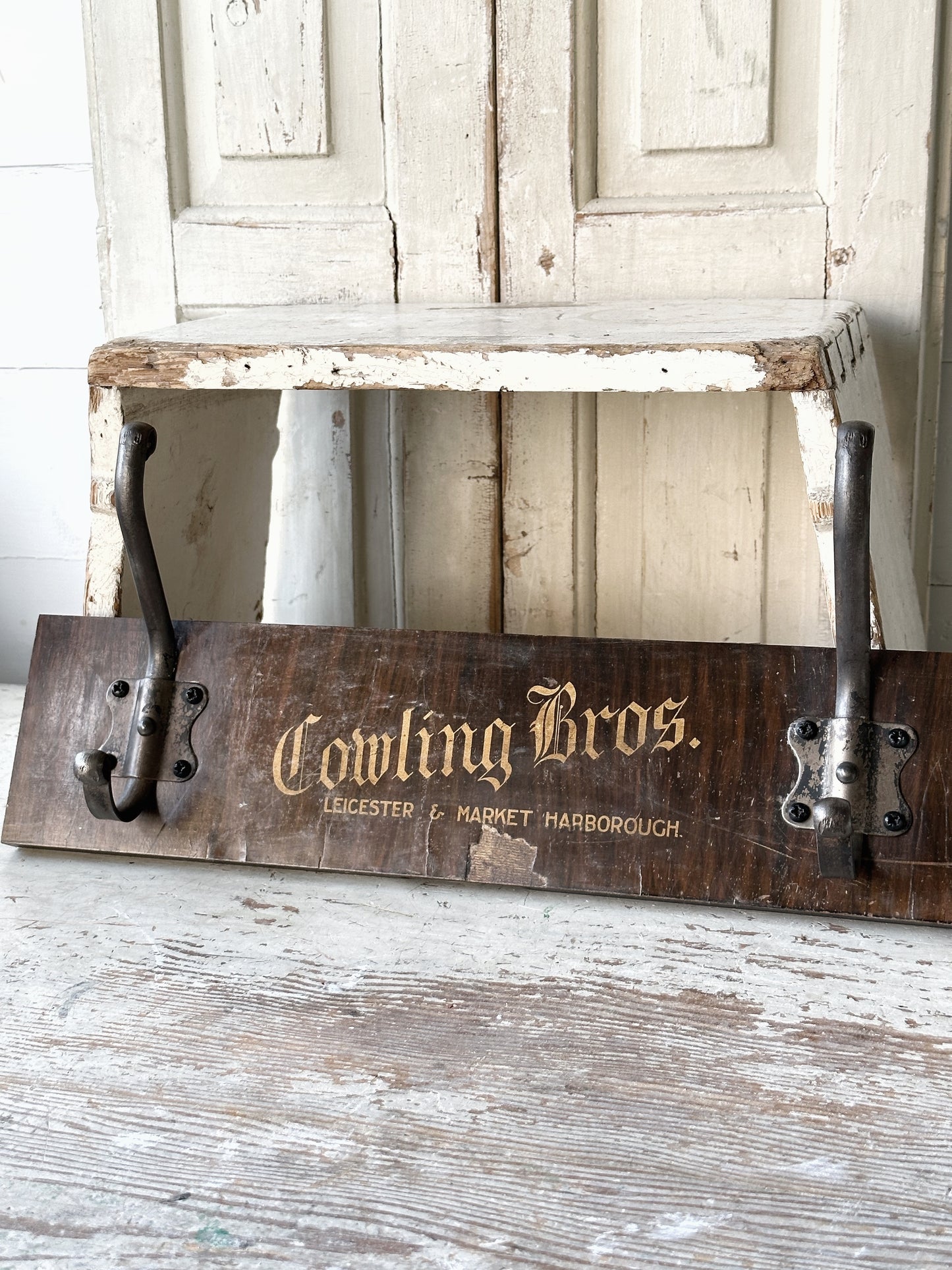 Salvaged sign written drawer front coat pegs