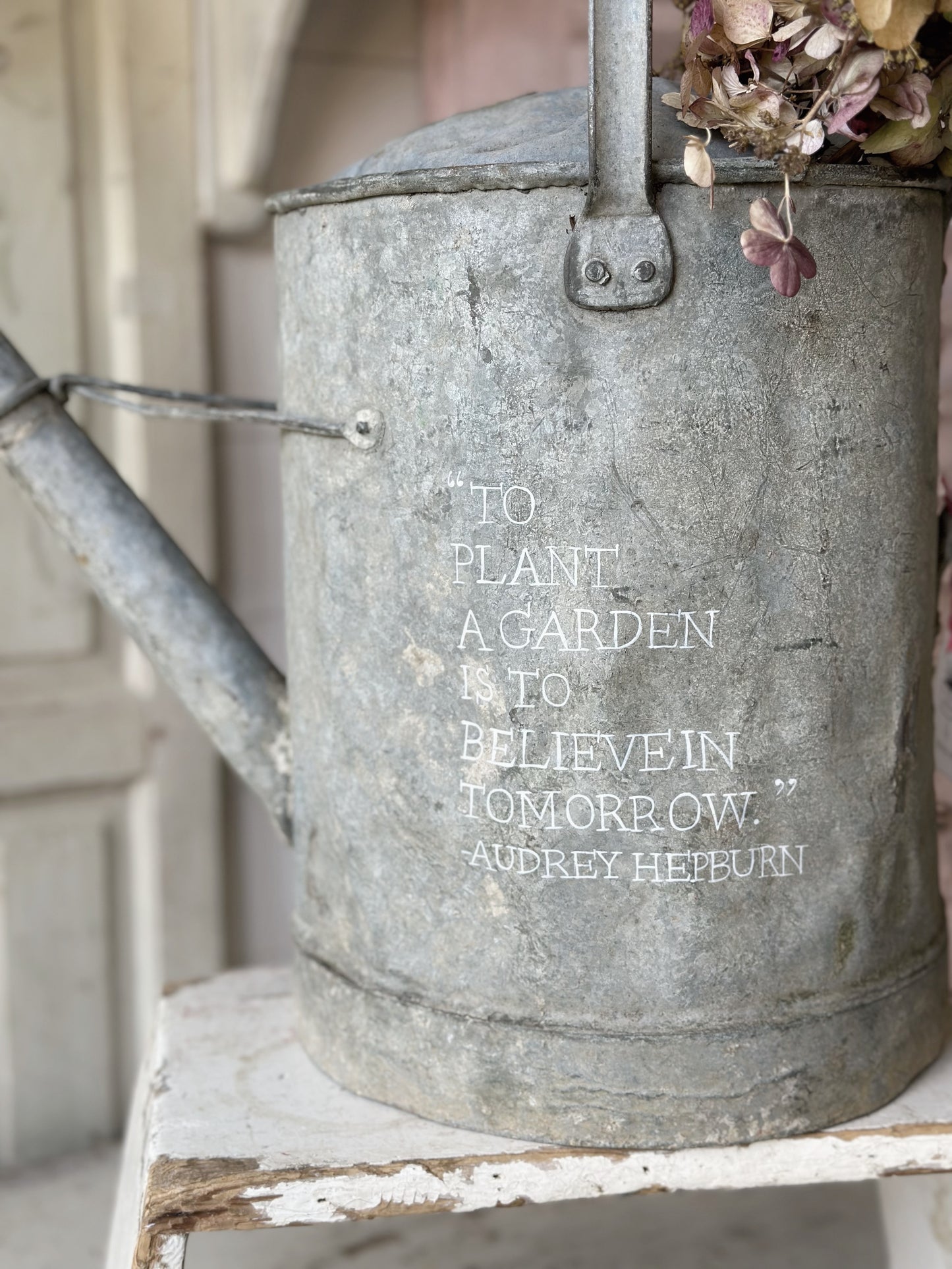 A beautiful vintage galvanised watering can planter