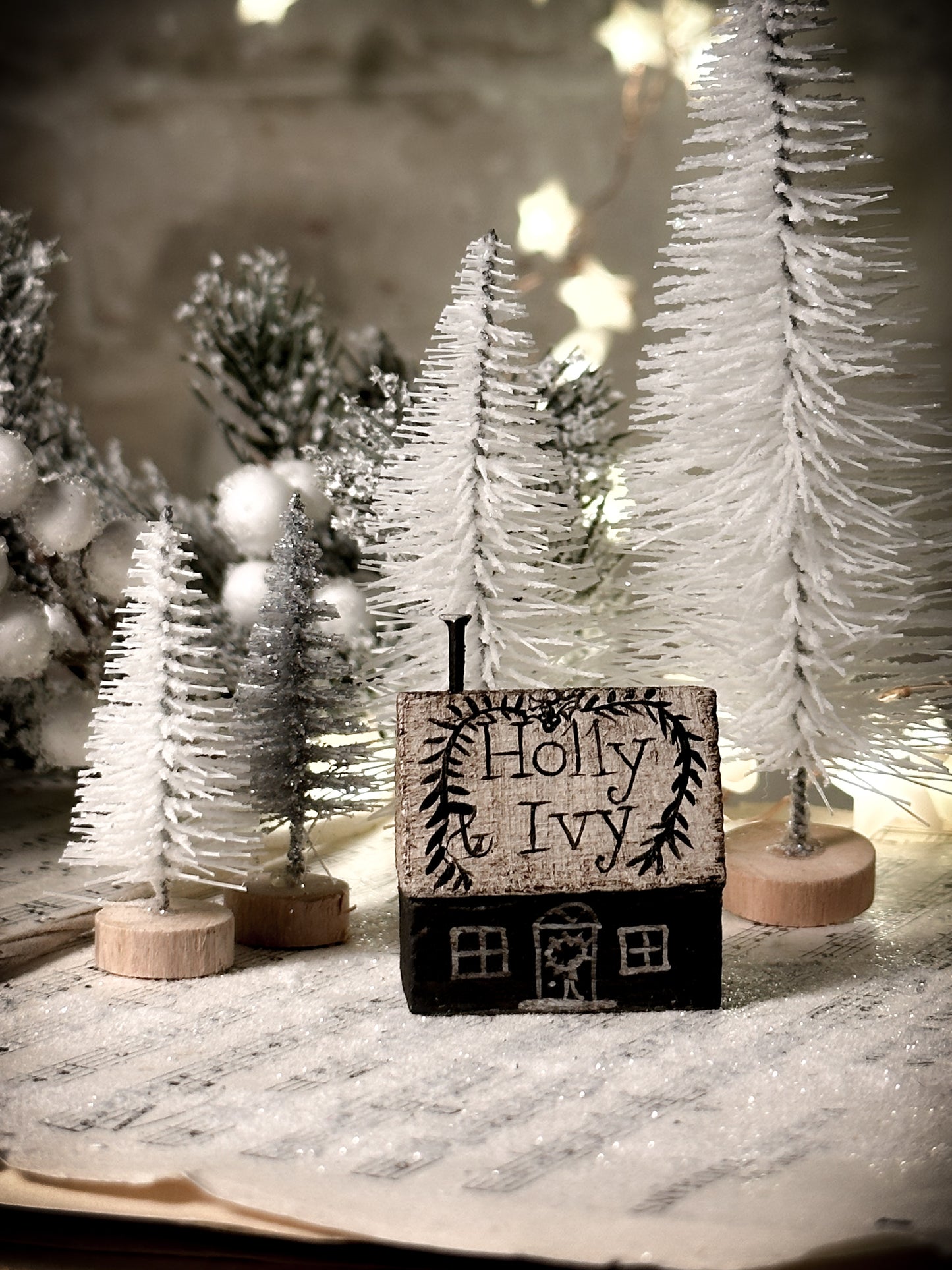 A pretty vintage German Erzgebirge Putz wooden village house painted with a Christmas quote