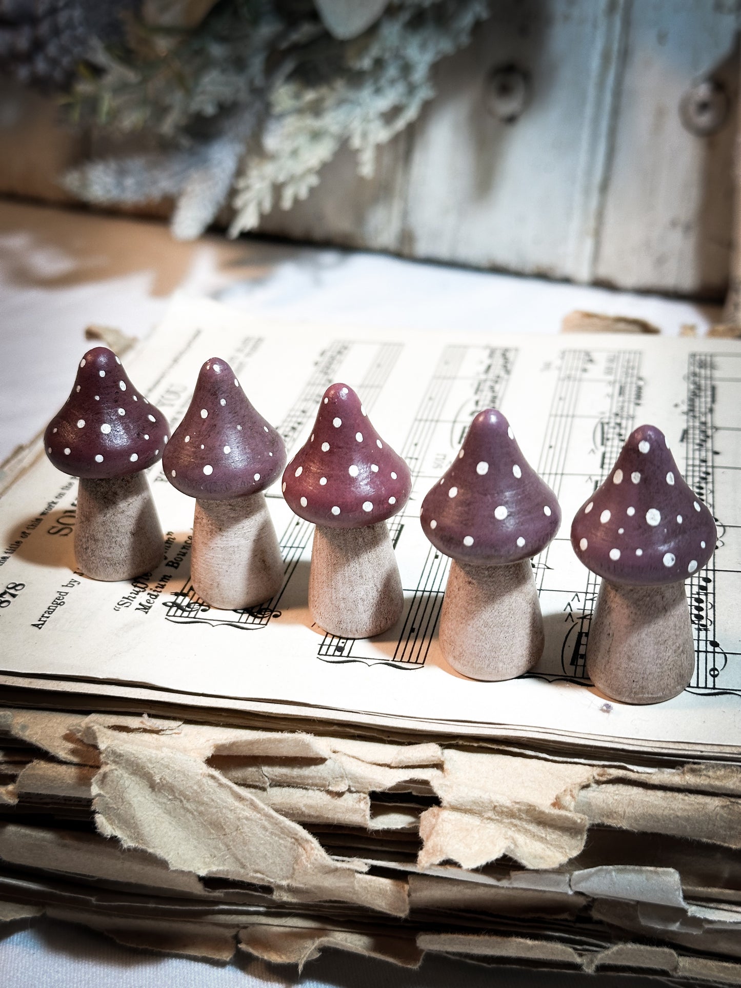 A wooden hand painted Christmas village toadstool