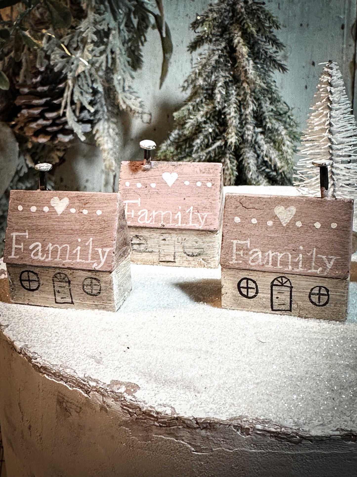 A pretty vintage German Erzgebirge Putz wooden village house painted with a Christmas quote