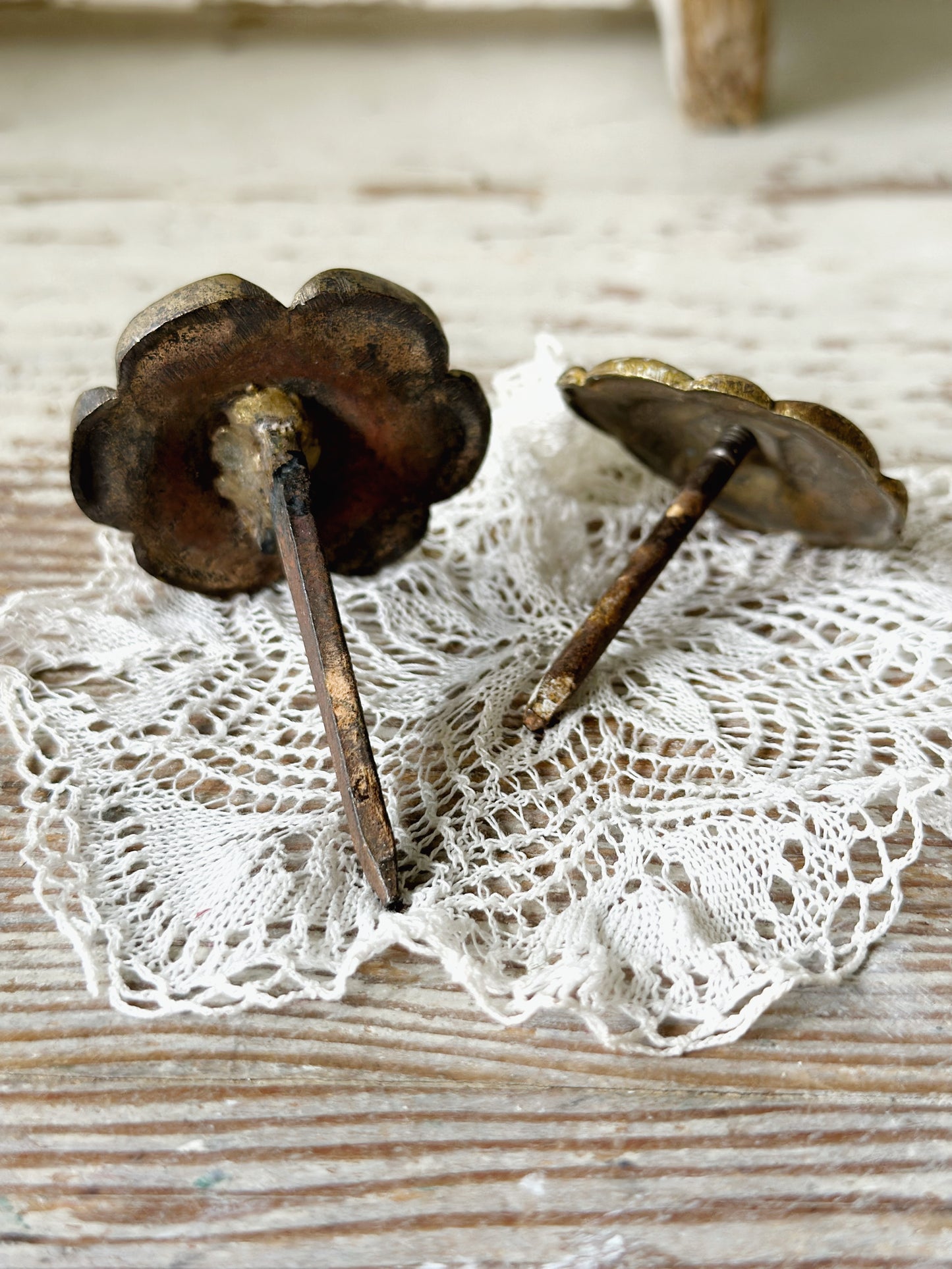 A pair of antique brass salvaged French curtain tie back hooks