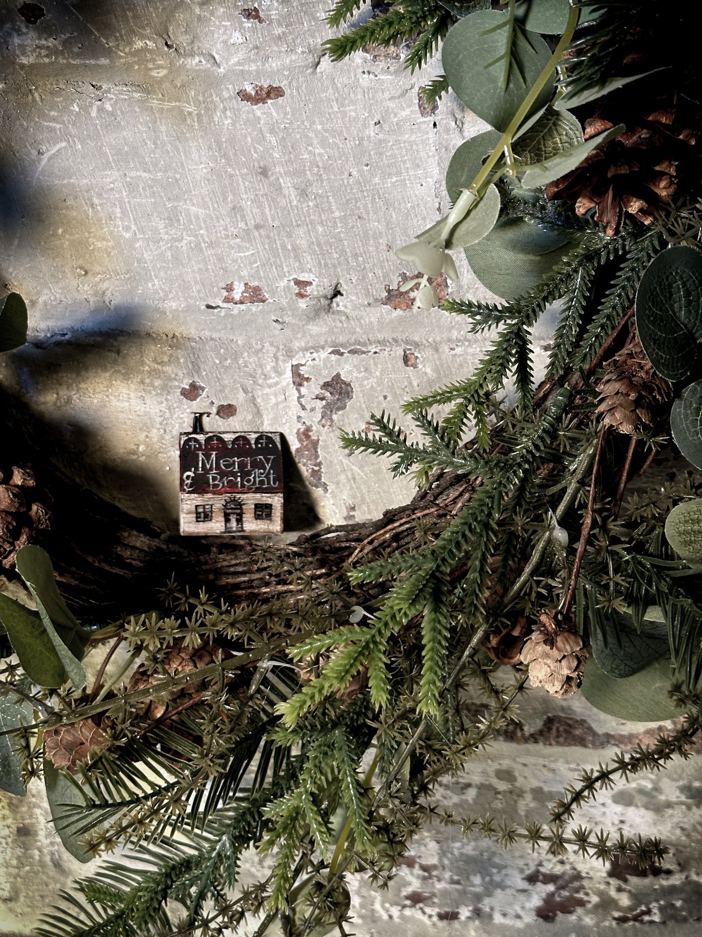 A pretty vintage German Erzgebirge Putz wooden village house painted with a Christmas quote