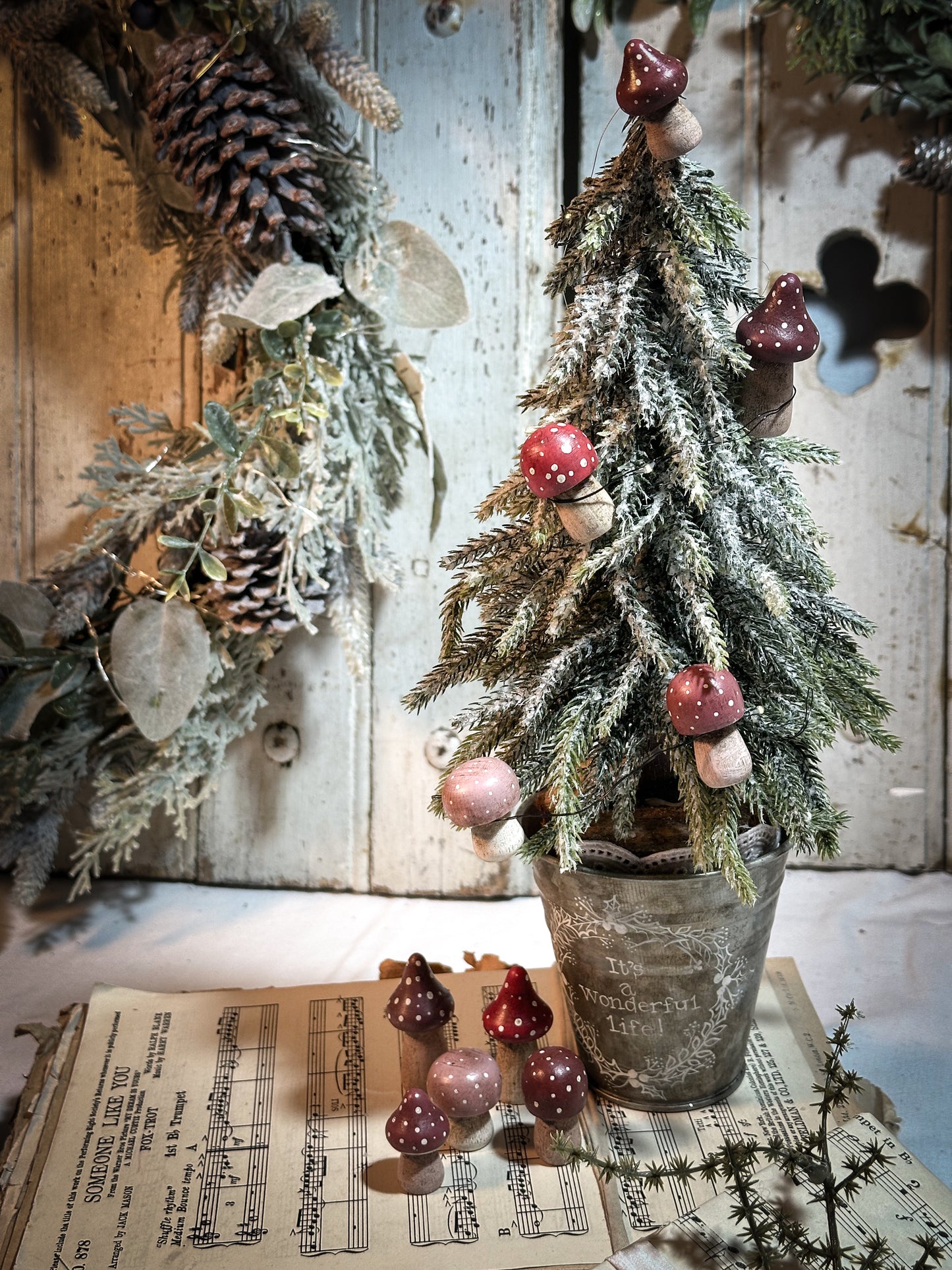 A wooden hand painted Christmas village toadstool
