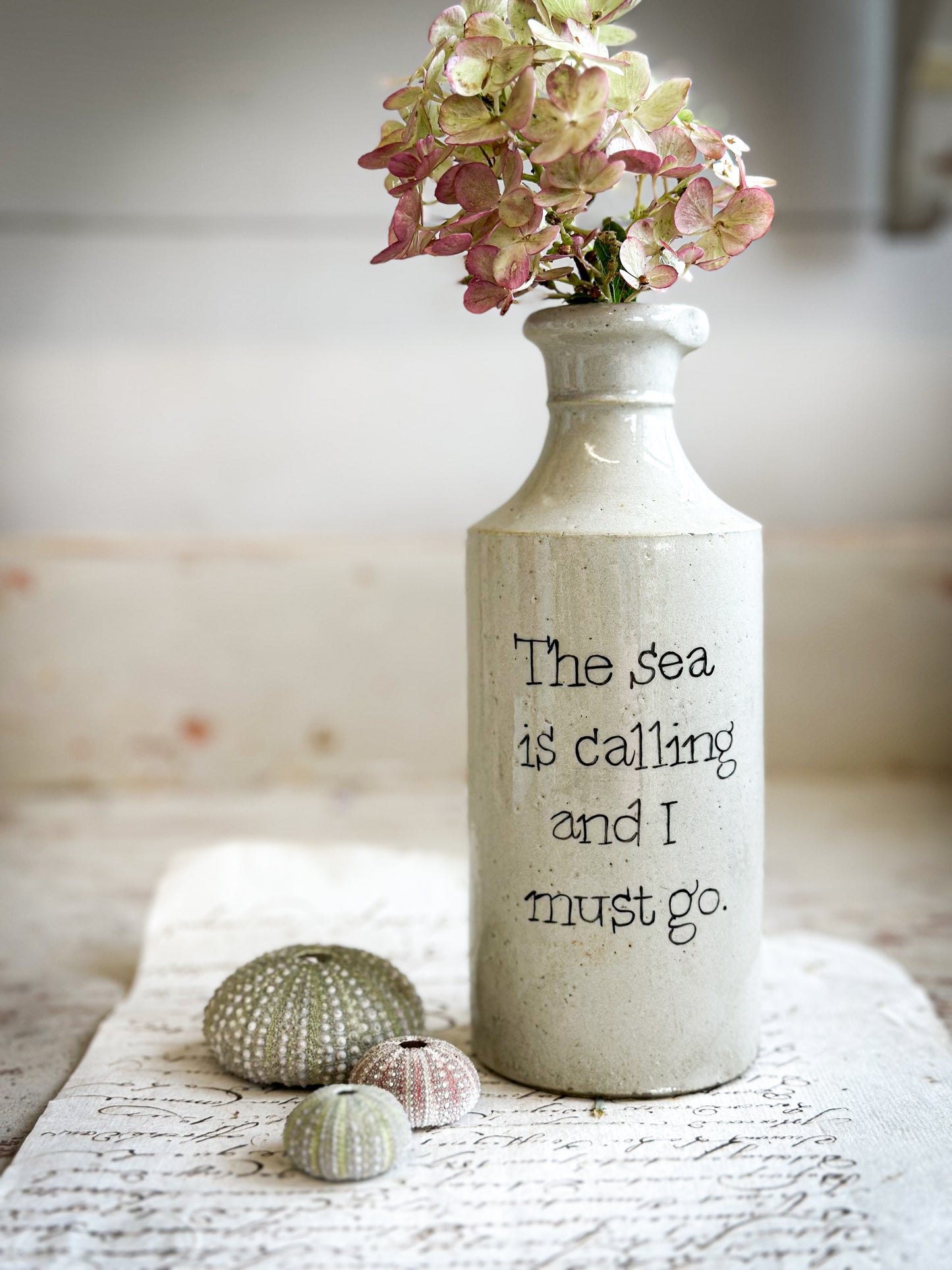 A Victorian unearthed short stoneware pottery bottle with a hand painted quote