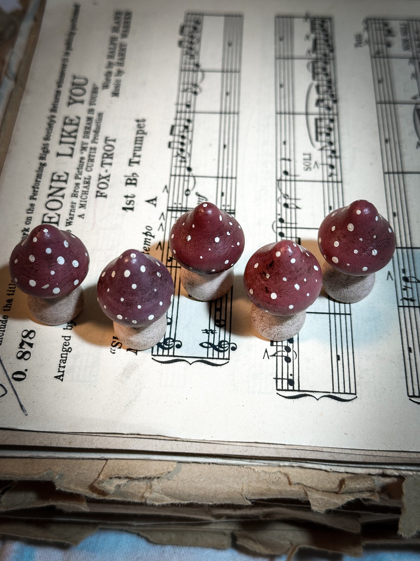 A wooden hand painted and trimmed Christmas village toadstool