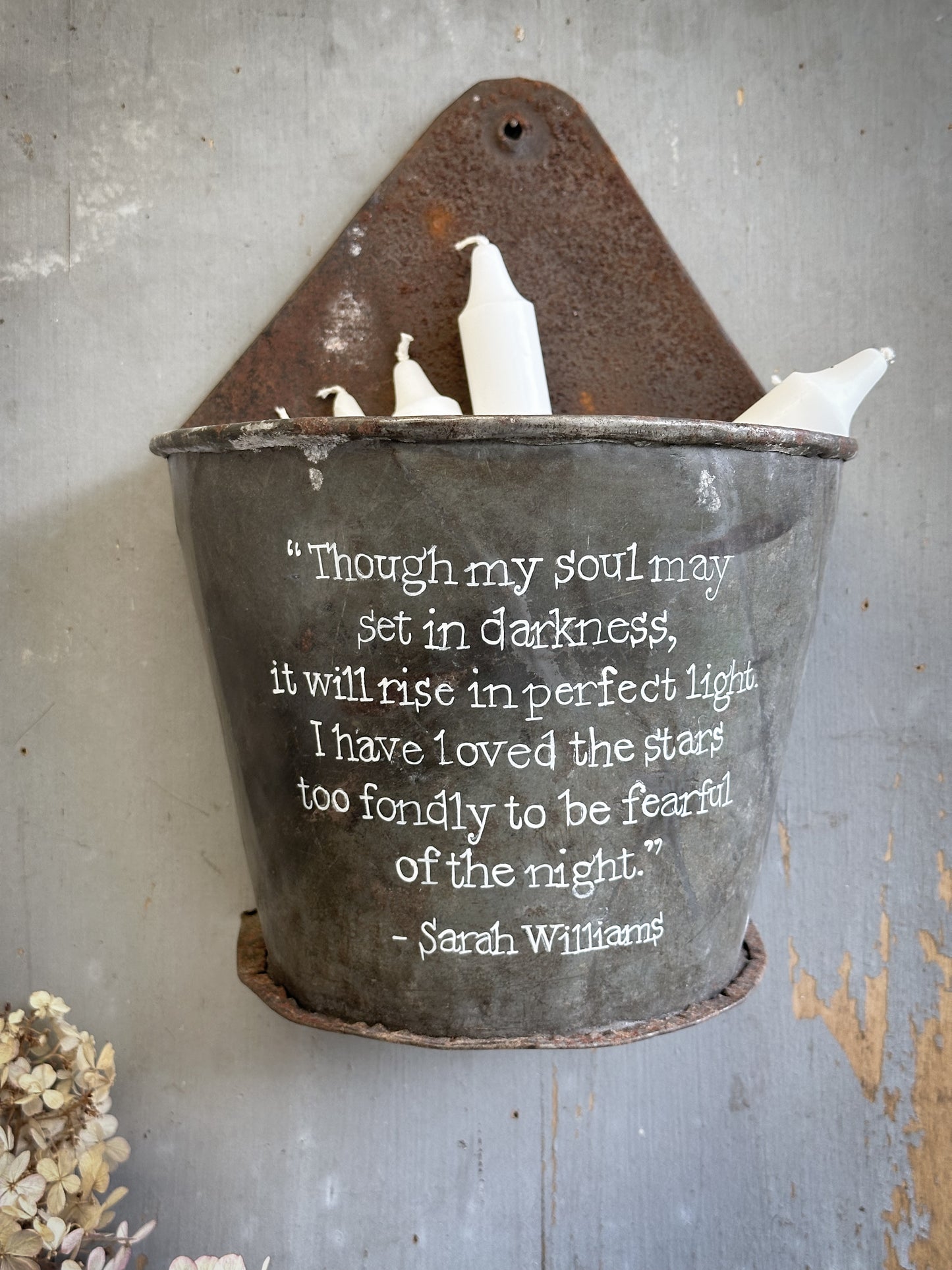 A Recycled Metal Candle Store With A Hand Painted Quote