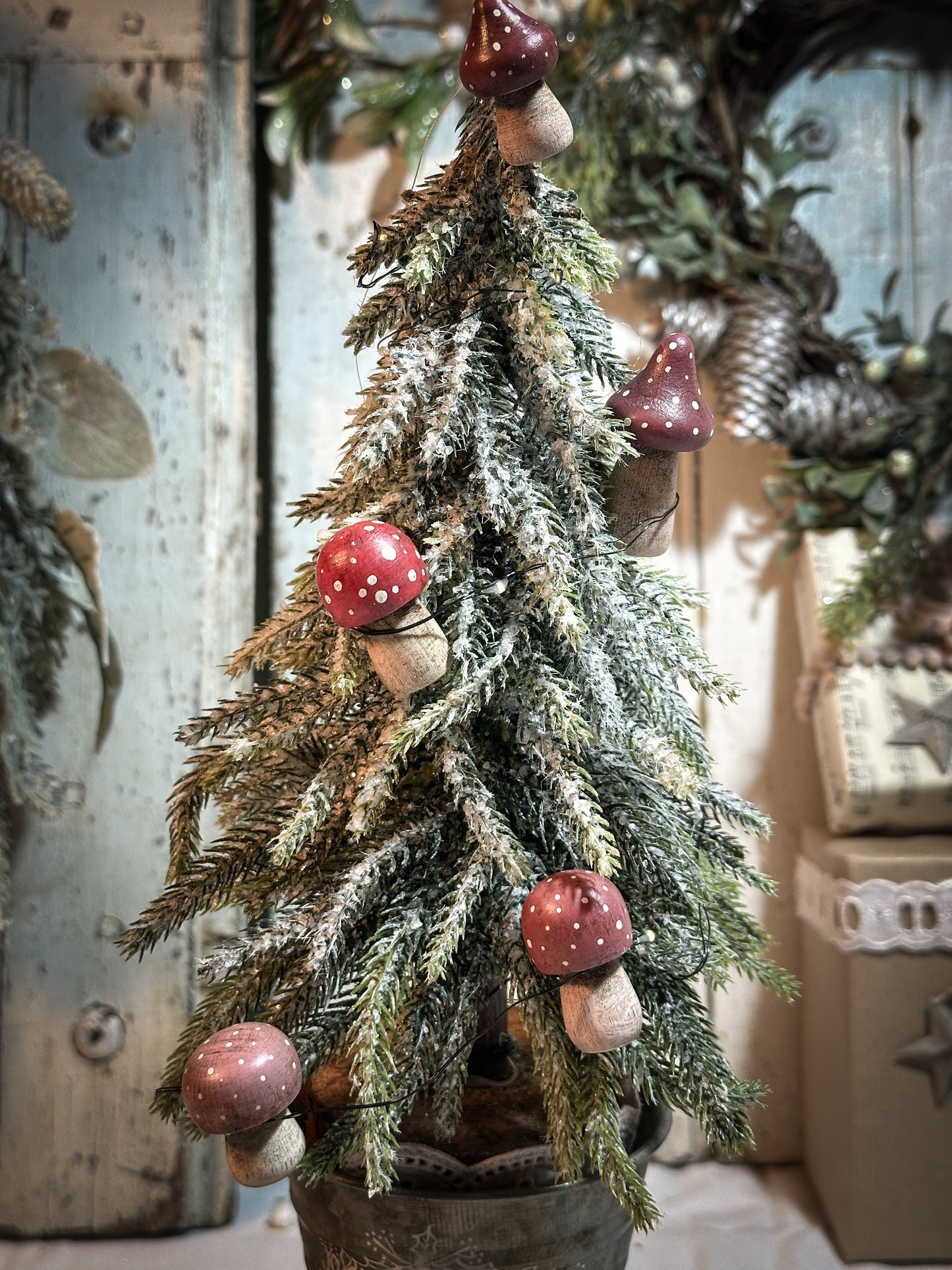 A wooden hand painted Christmas village toadstool