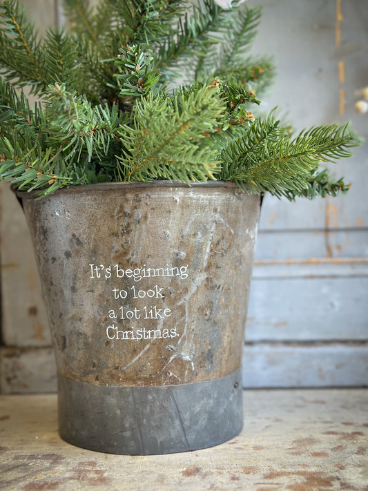 A Recycled Metal Small Christmas Tree Bucket With A Hand Painted Quote