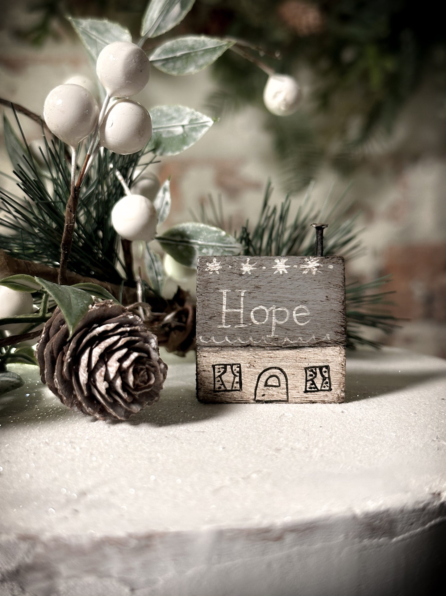 A pretty vintage German Erzgebirge Putz wooden village house painted with a Christmas quote
