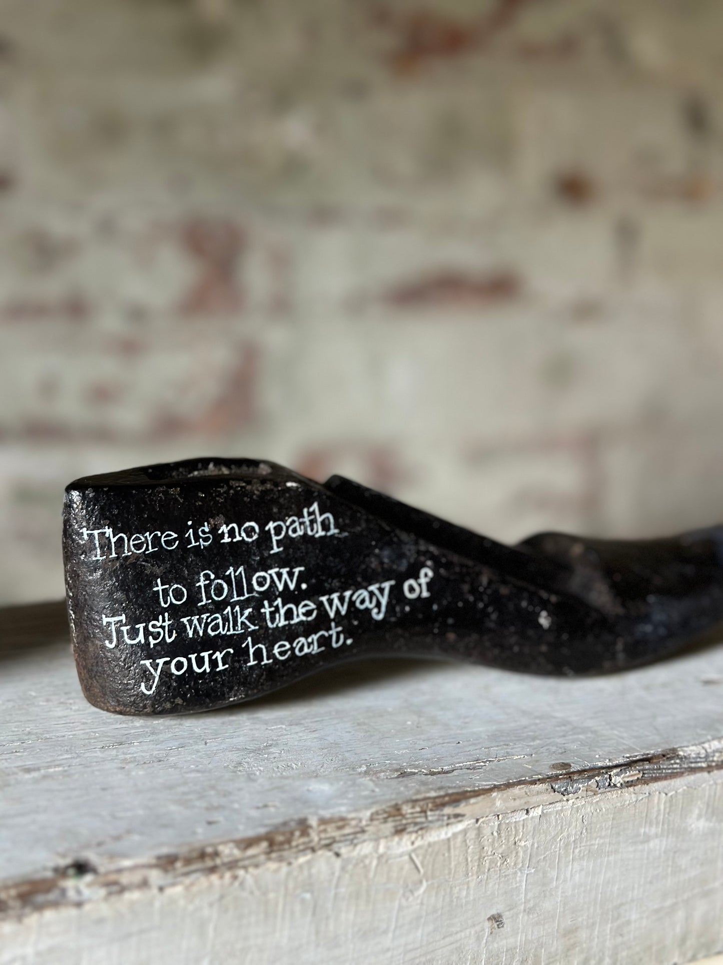 An antique cast iron painted adult’s shoe last.