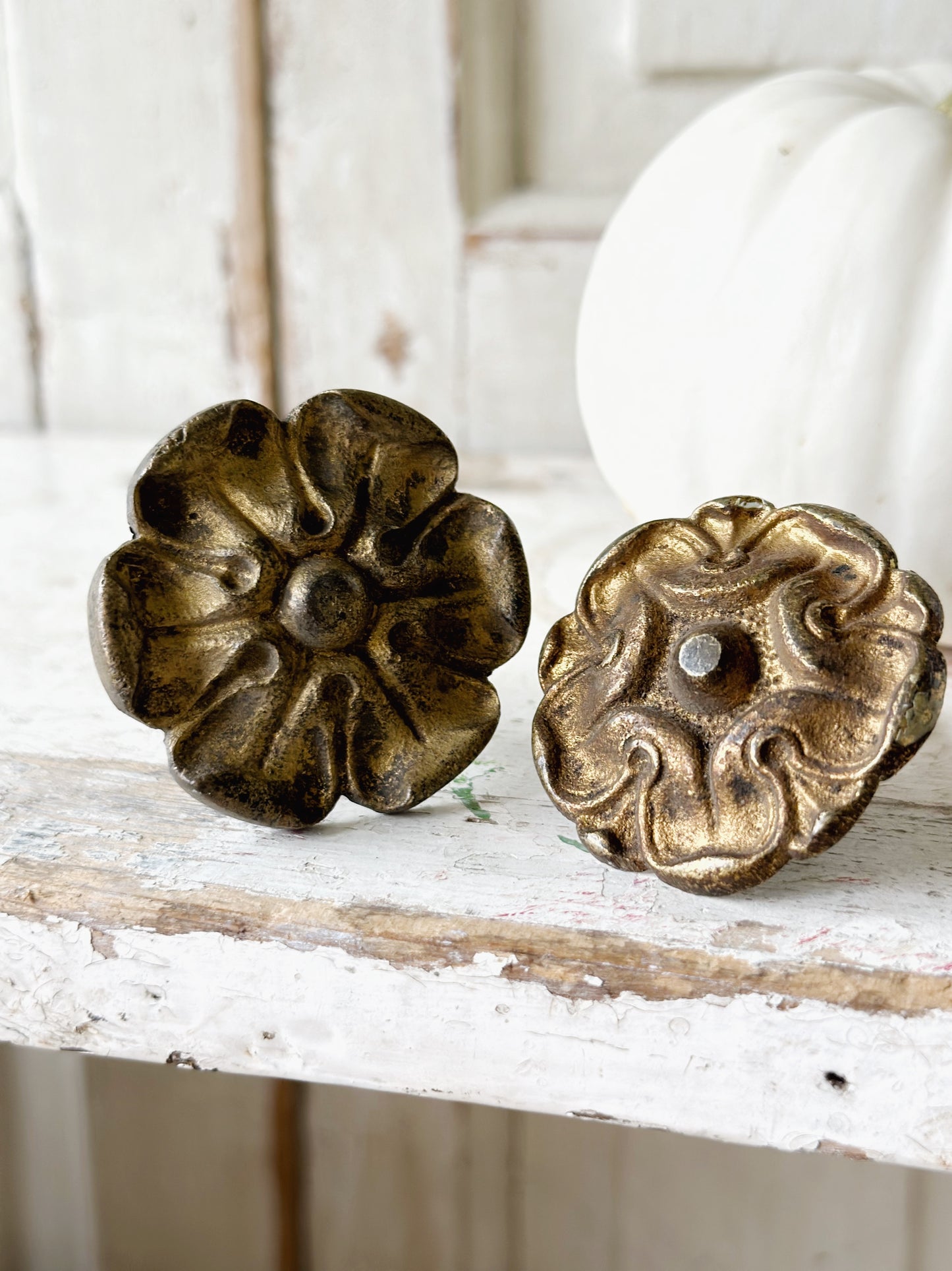 A pair of antique brass salvaged French curtain tie back hooks
