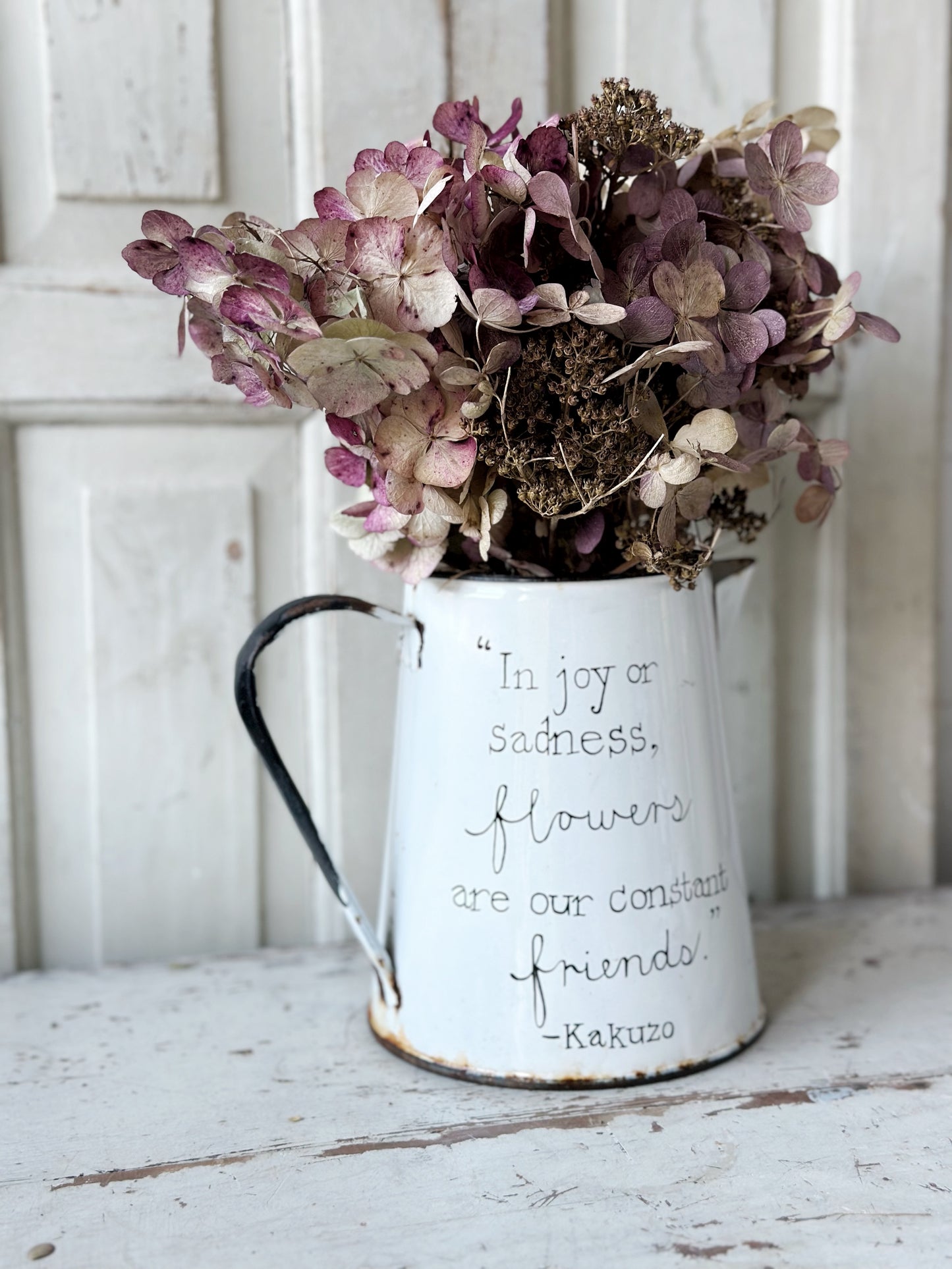 A hand painted quote on a beautiful Vintage white enamelware jug