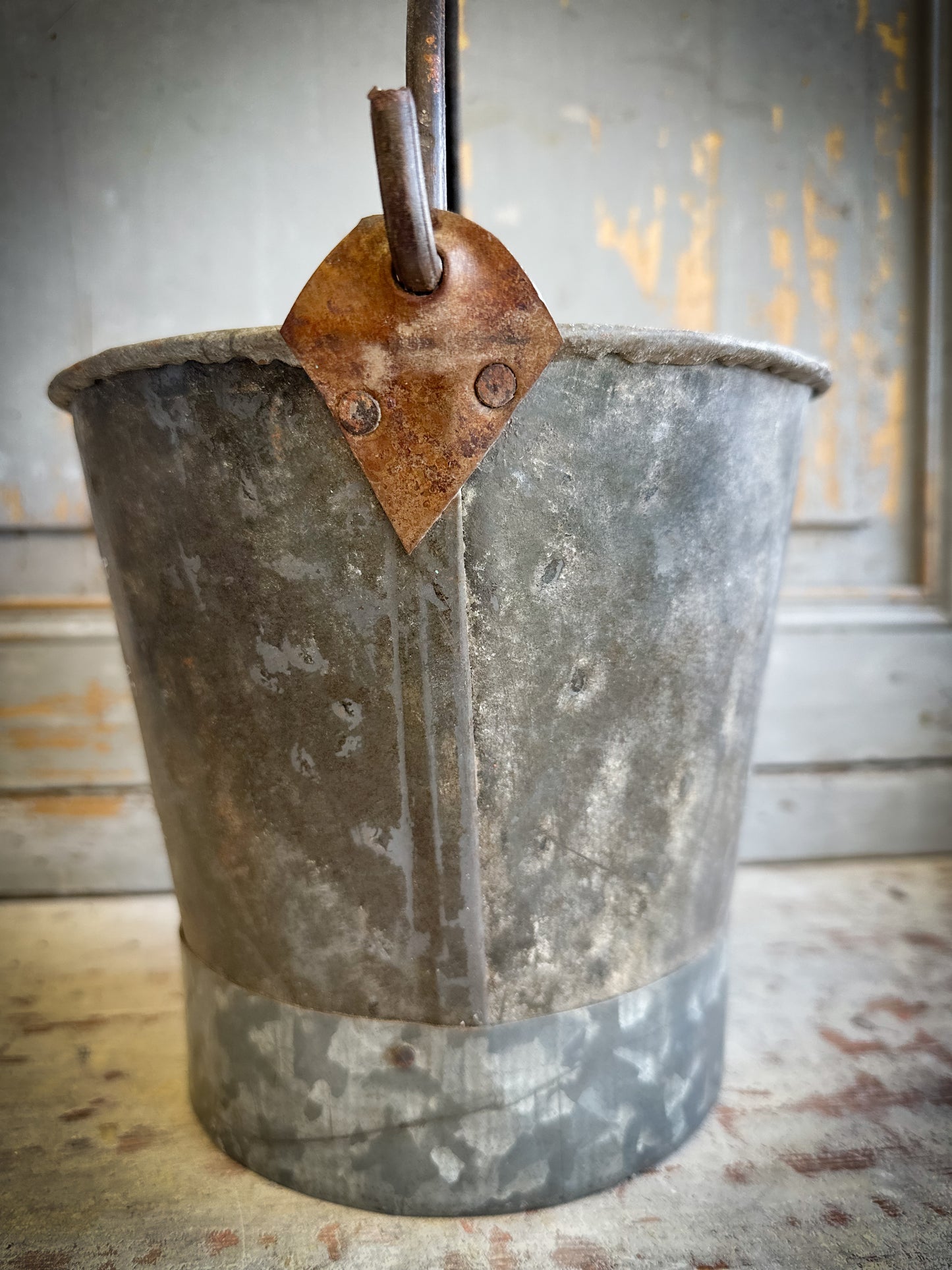 A Recycled Metal Small Christmas Tree Bucket With A Hand Painted Quote