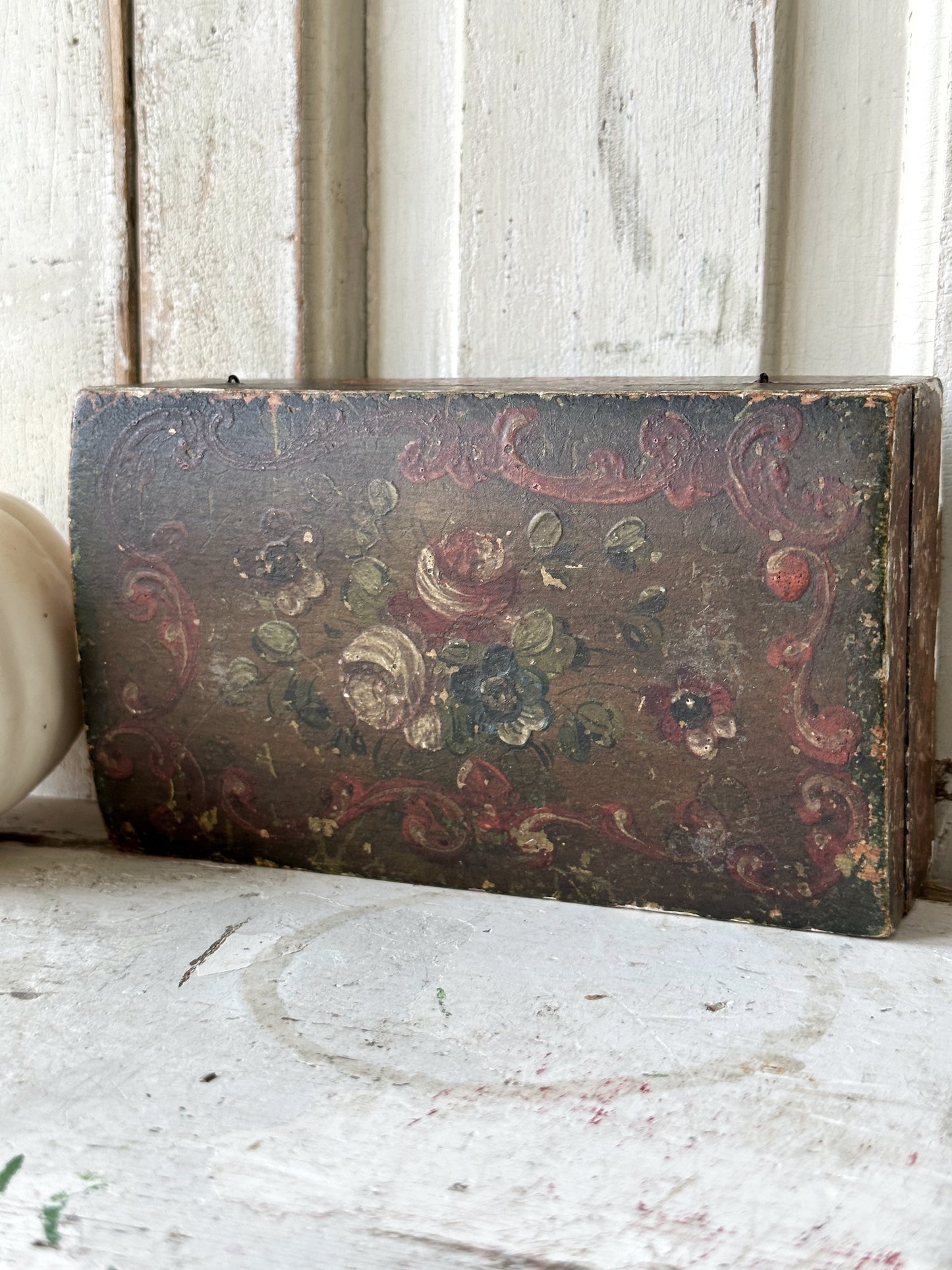 A beautiful antique painted box with floral detail