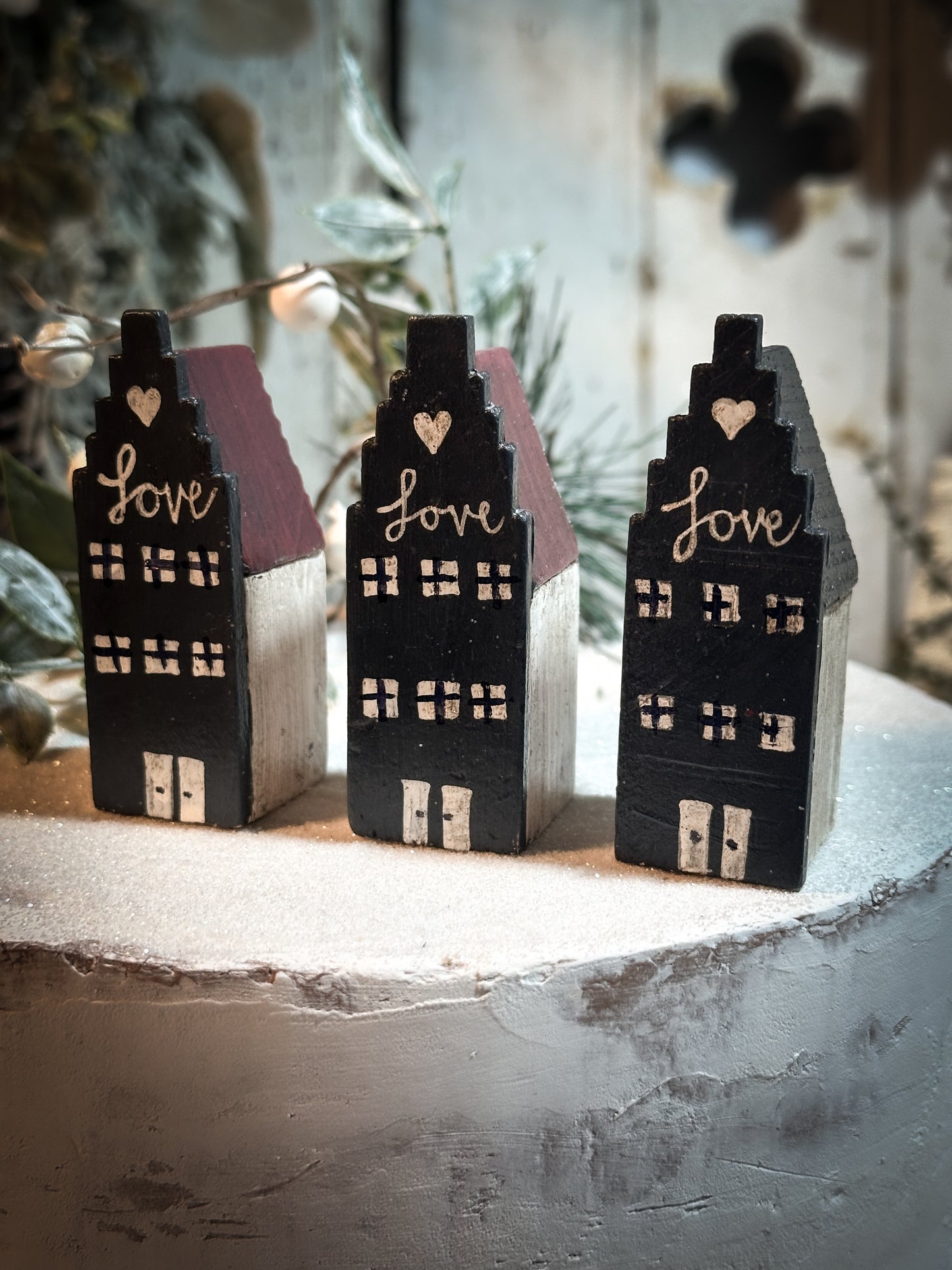 A pretty vintage German Erzgebirge Putz wooden village house painted with a Christmas quote