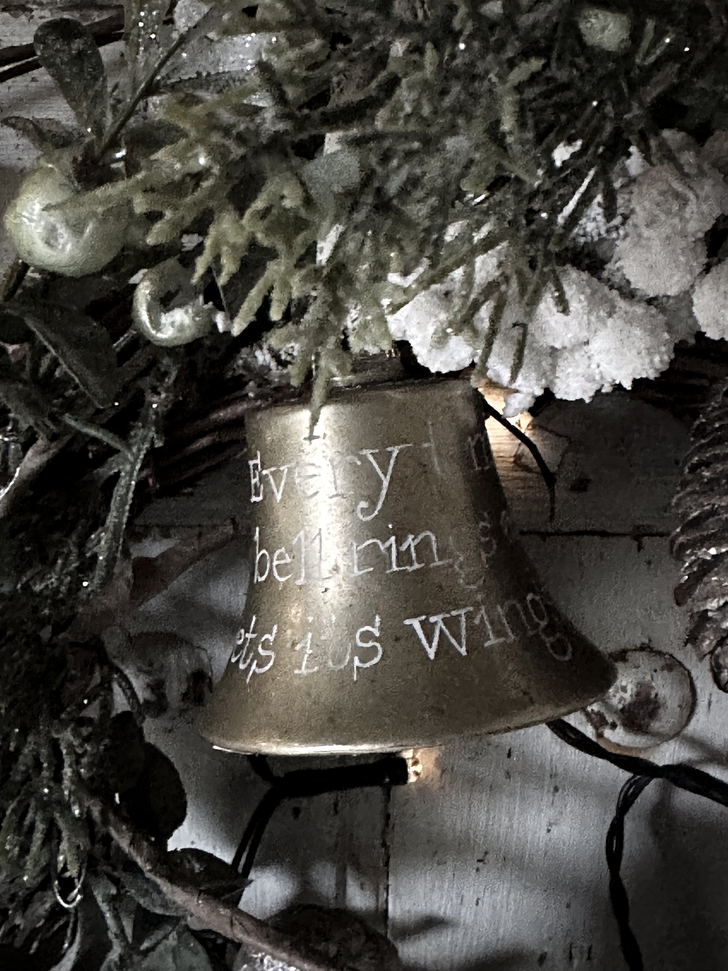 A vintage brass bell with a hand painted quote