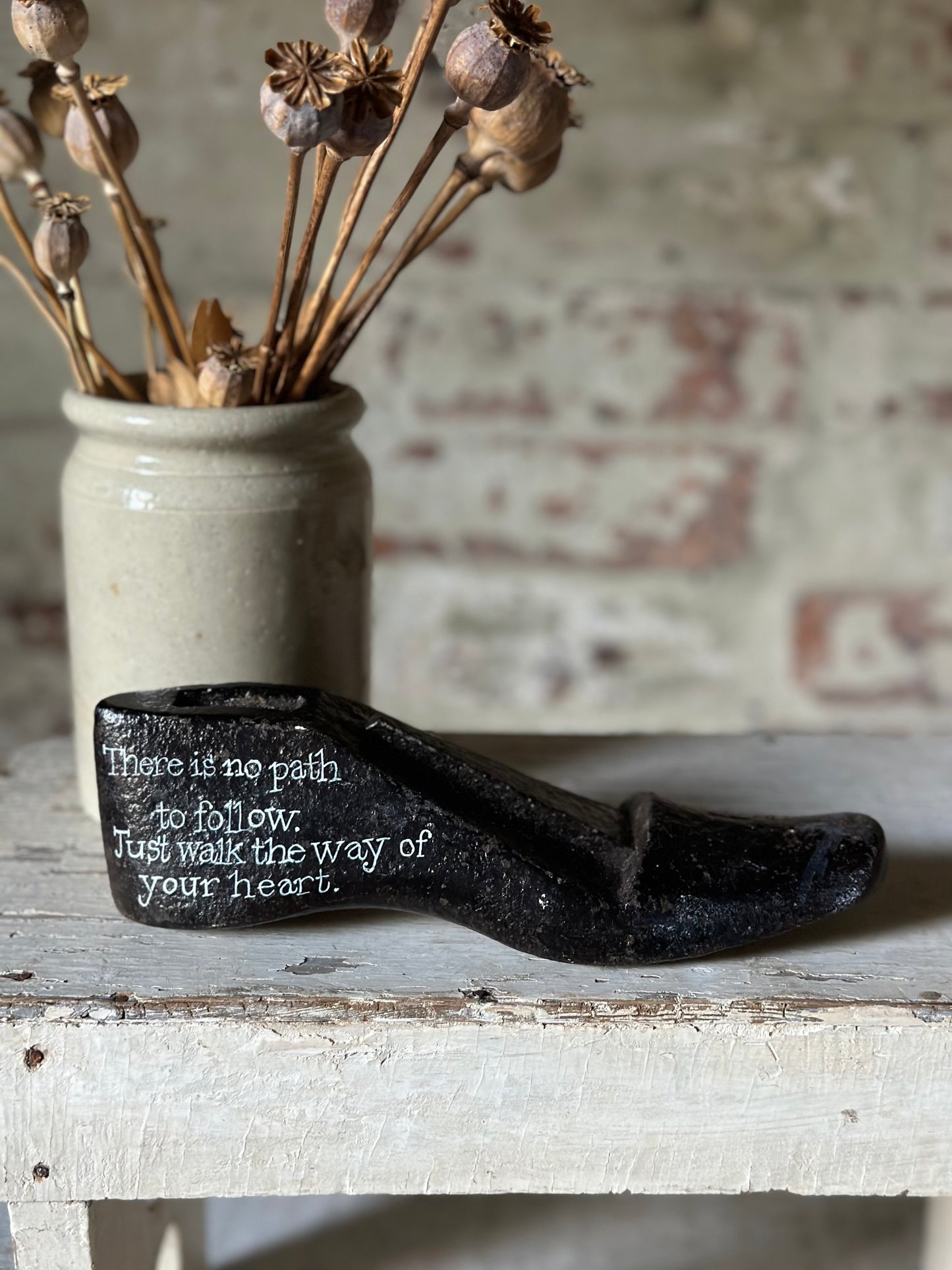 An antique cast iron painted adult’s shoe last.