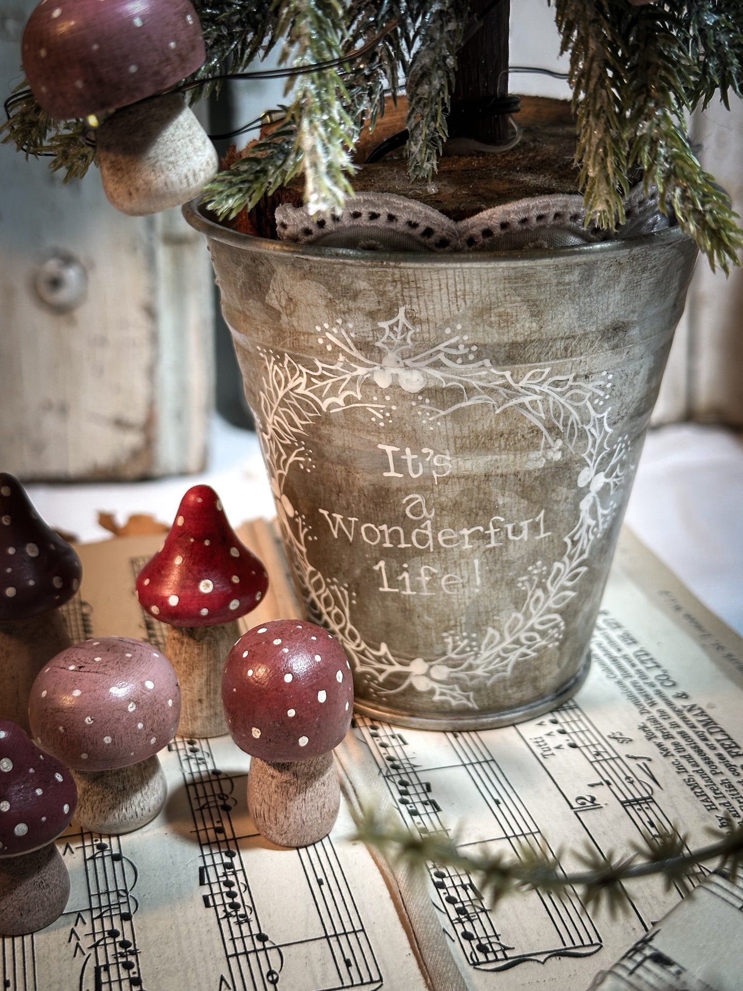A wooden hand painted and trimmed Christmas village toadstool
