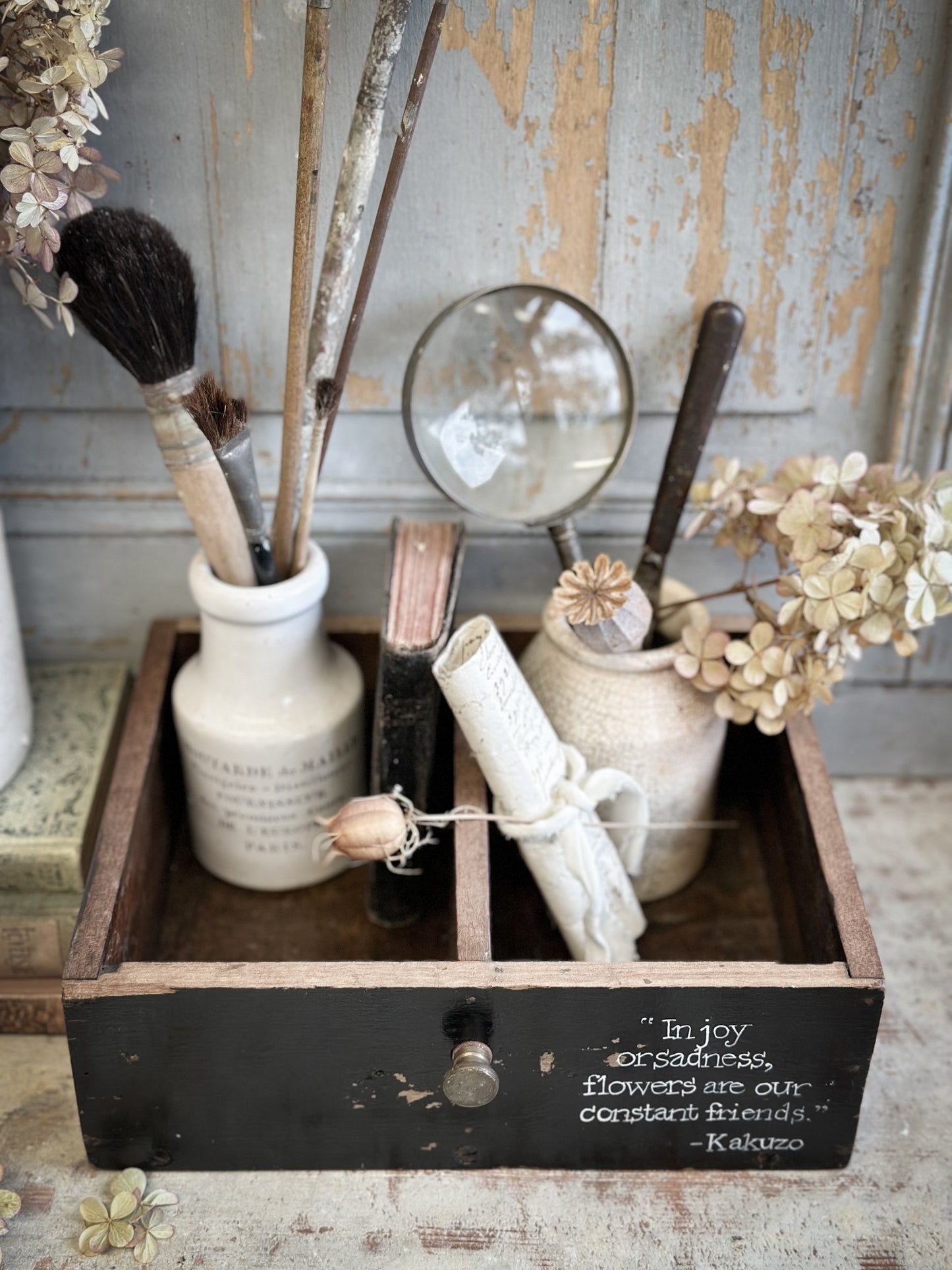 A Vintage Wooden Drawer With Hand Painted Quote