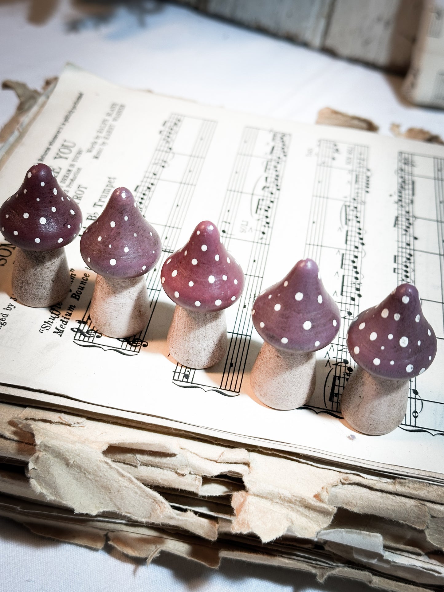 A wooden hand painted Christmas village toadstool