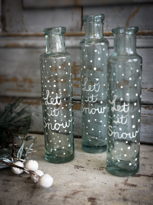 A beautiful Victorian cylinder bottle painted with a Christmas quote “Let it Snow”