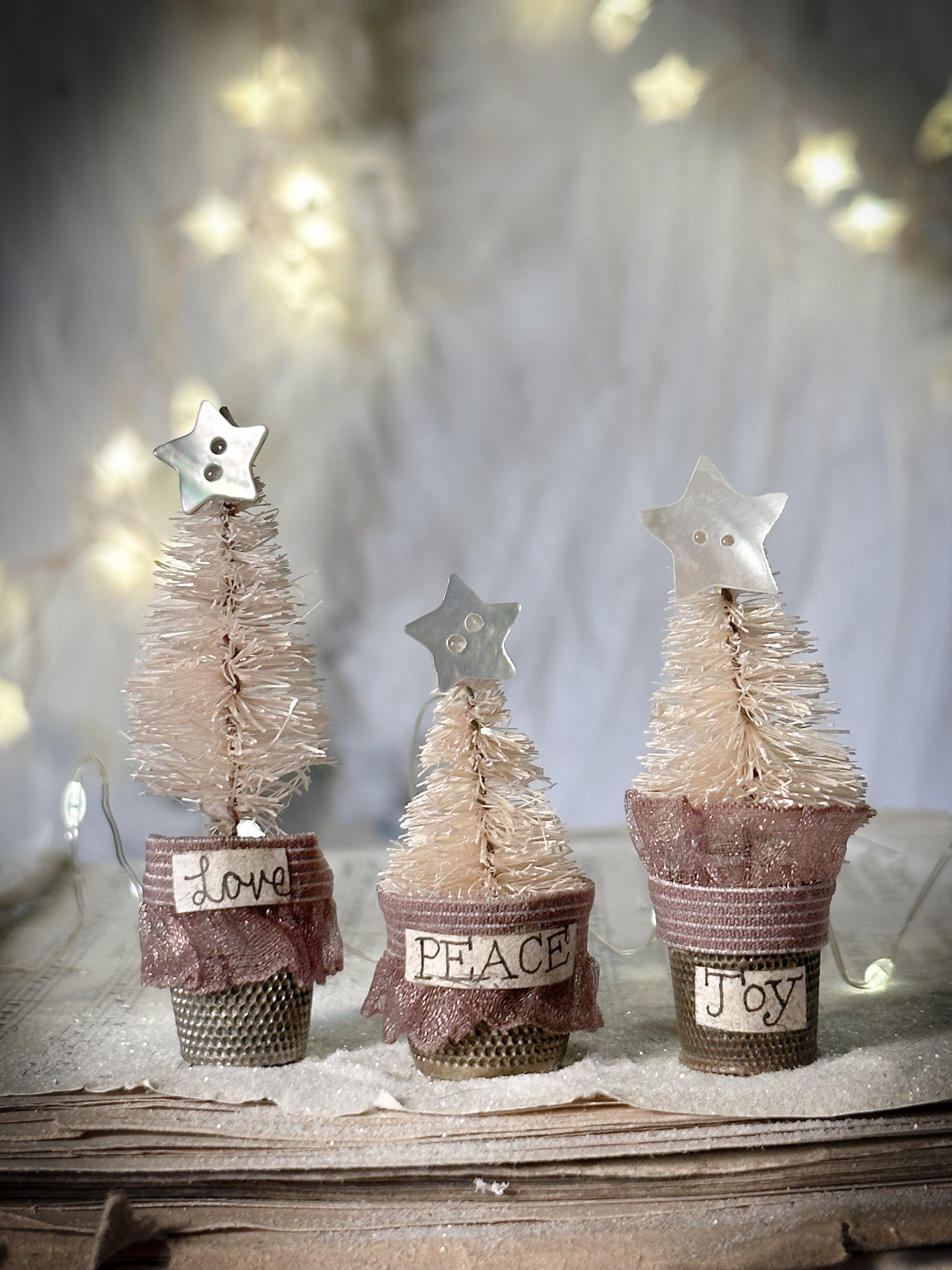 A set of three thimble Christmas trees