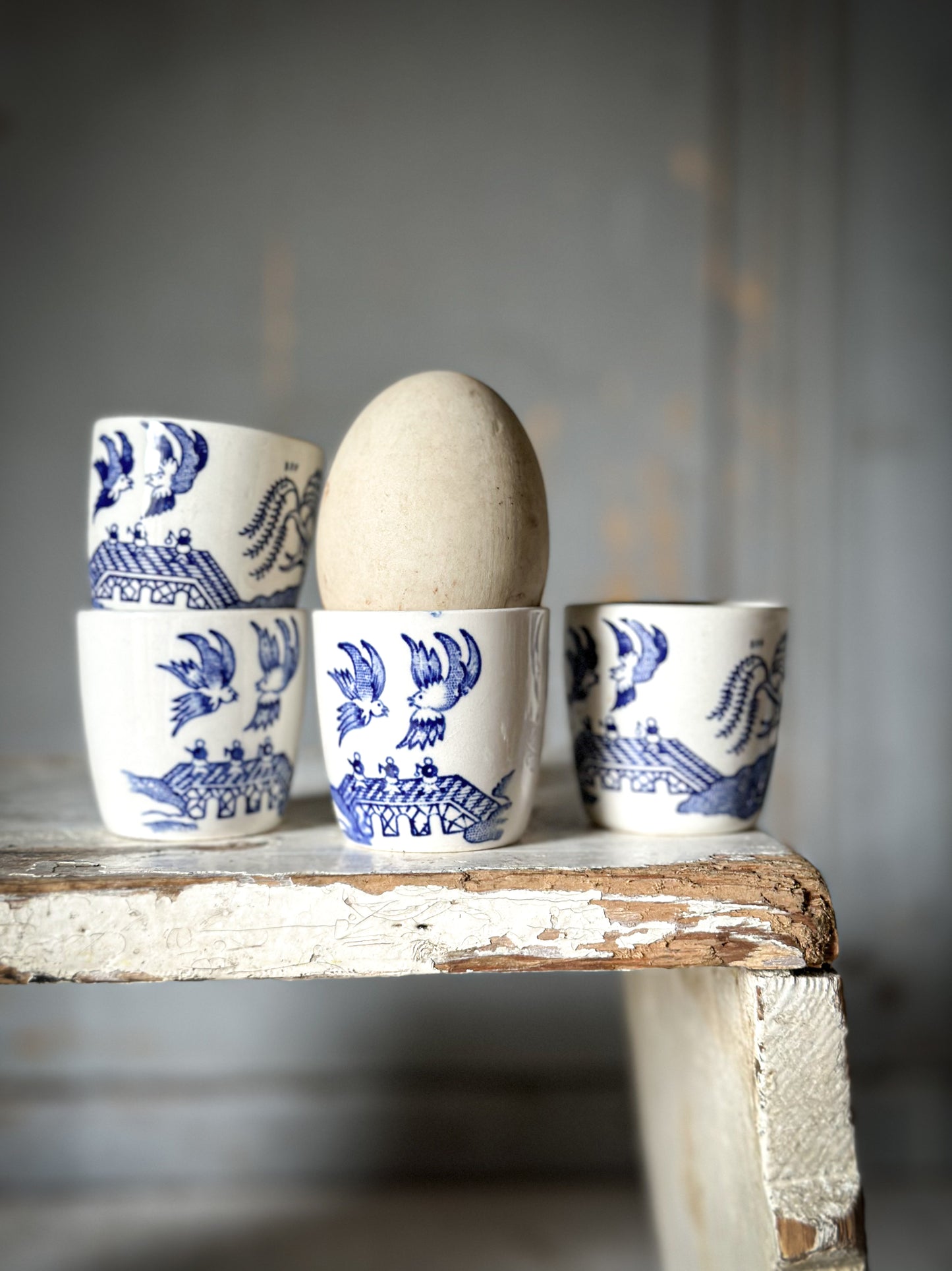 A set of four pretty Staffordshire pottery blue and white Willow Pattern egg cups