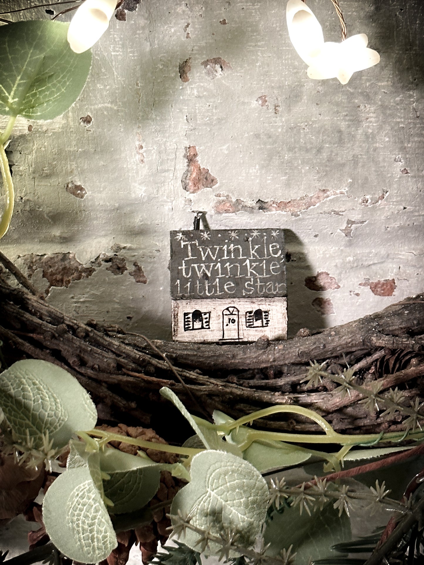 A pretty vintage German Erzgebirge Putz wooden village house painted with a Christmas quote