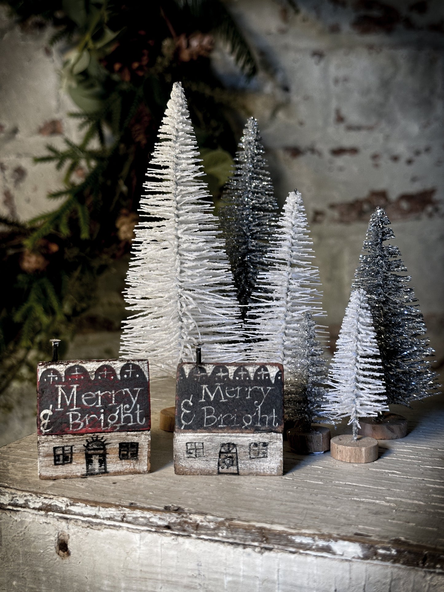 A pretty vintage German Erzgebirge Putz wooden village house painted with a Christmas quote