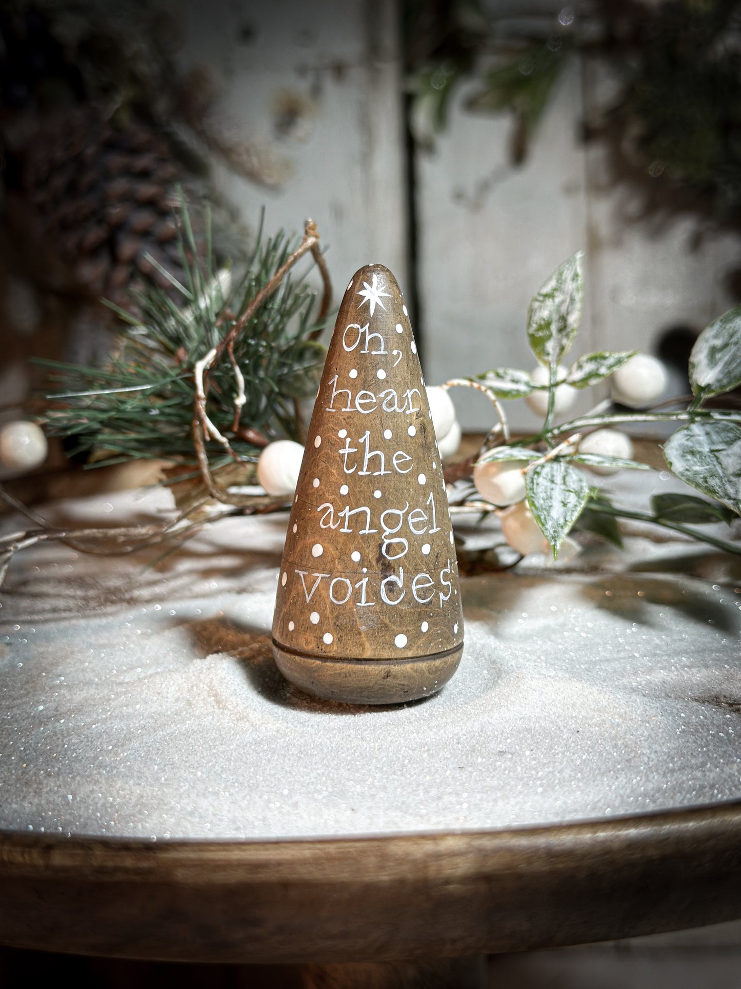 A hand painted quote on a lignum vitae wood plumber’s turnpin with a Christmas quote
