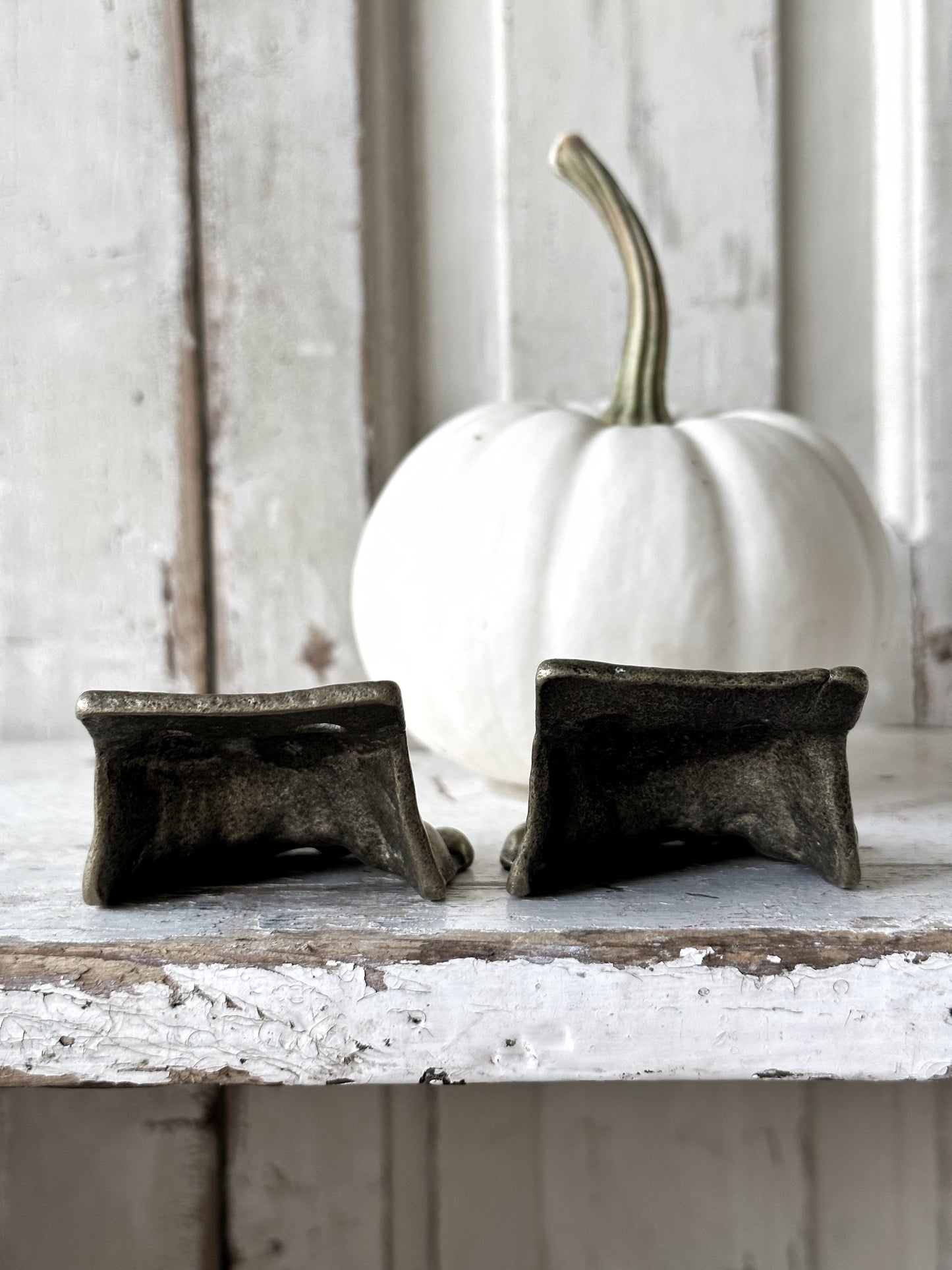 A pair of two antique brass salvaged clawed feet for furniture