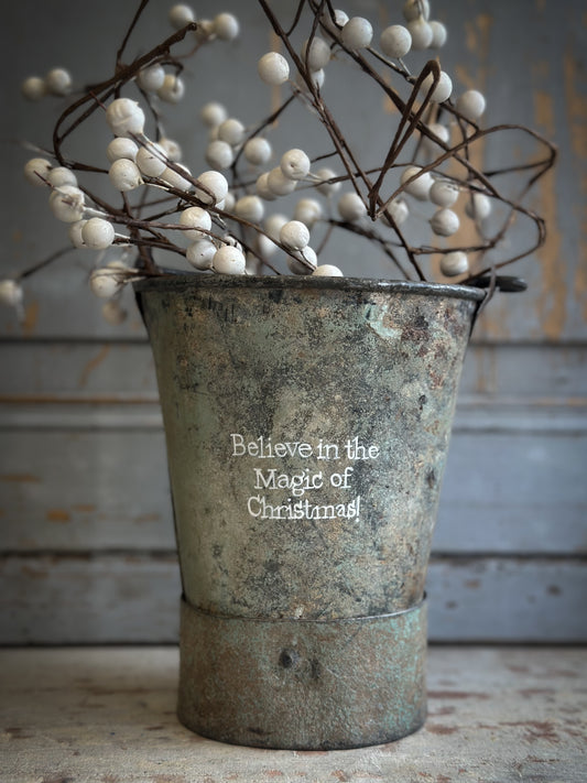 A Recycled Metal Mini Christmas Tree Bucket With A Hand Painted Quote