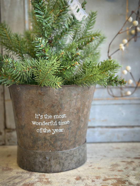 A Recycled Metal Small Christmas Tree Bucket With A Hand Painted Quote