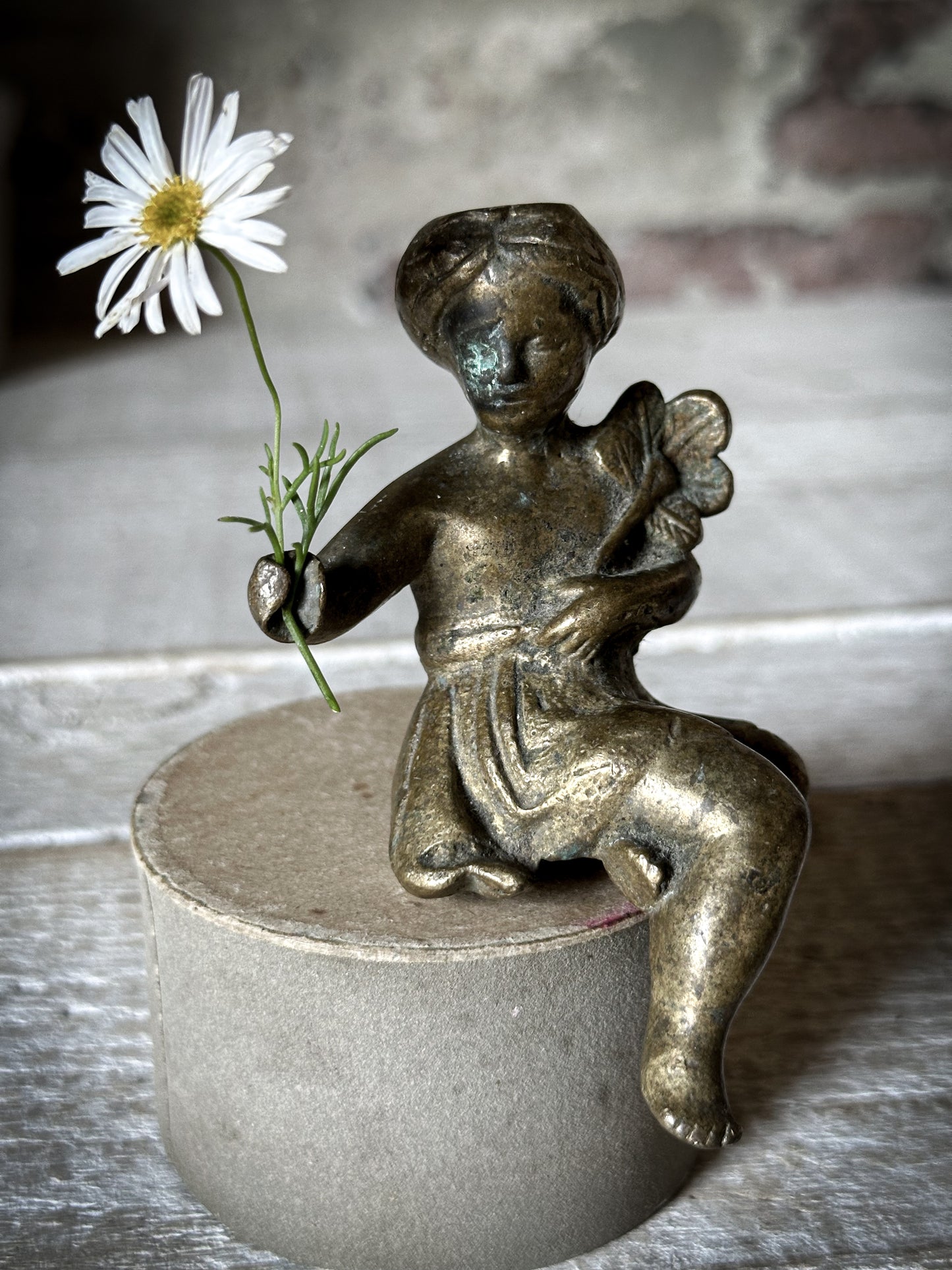 A Delightful Antique Bronze Decorative Seated Cherub