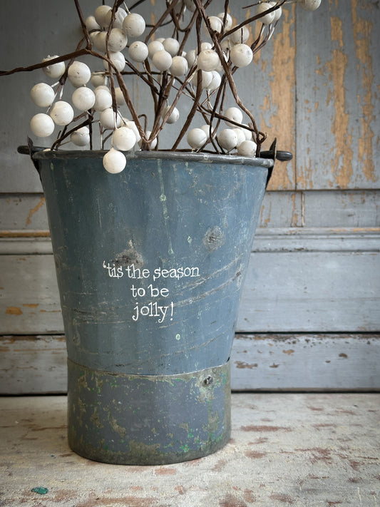 A Recycled Metal Mini Christmas Tree Bucket With A Hand Painted Quote