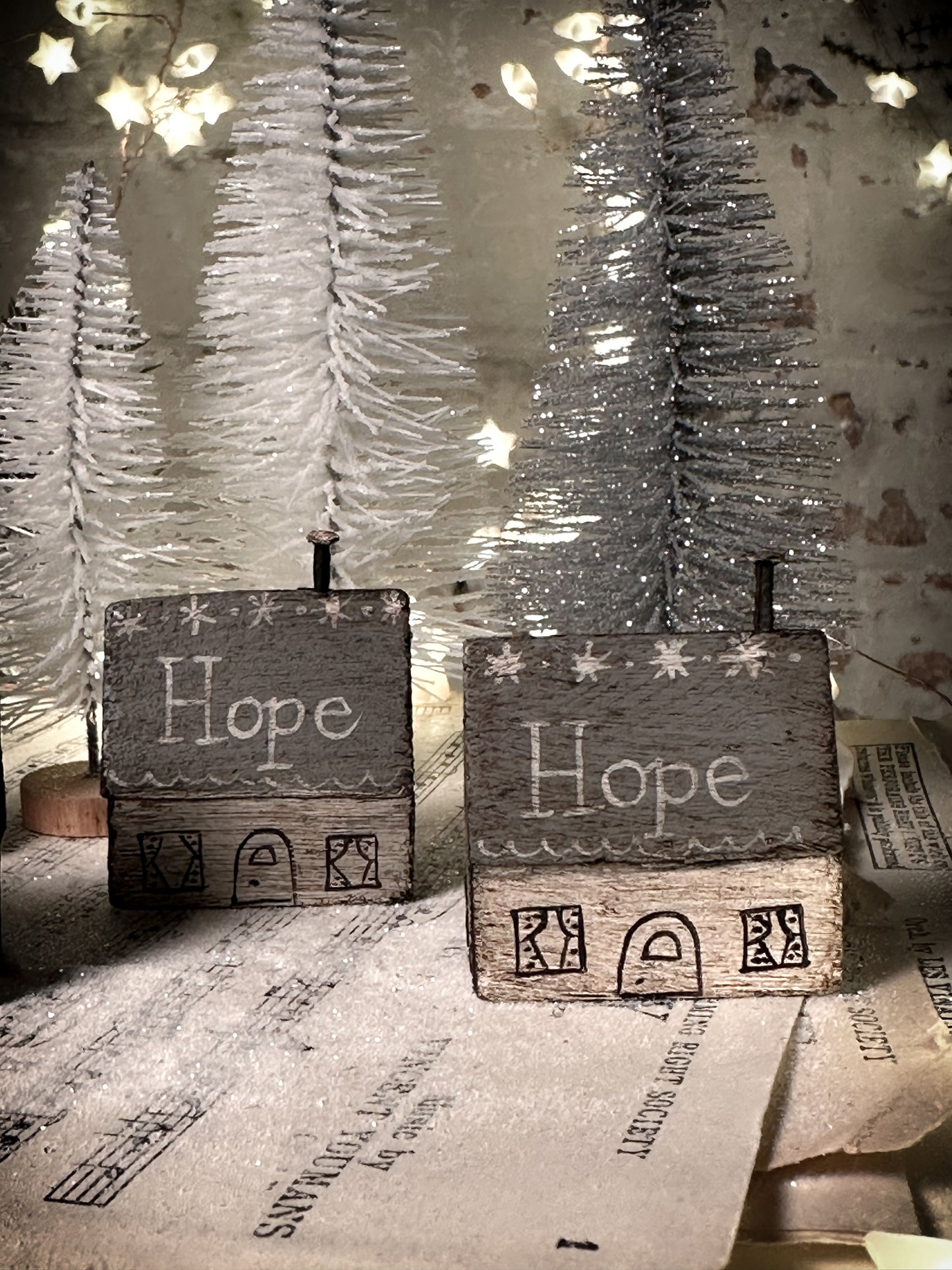 A pretty vintage German Erzgebirge Putz wooden village house painted with a Christmas quote