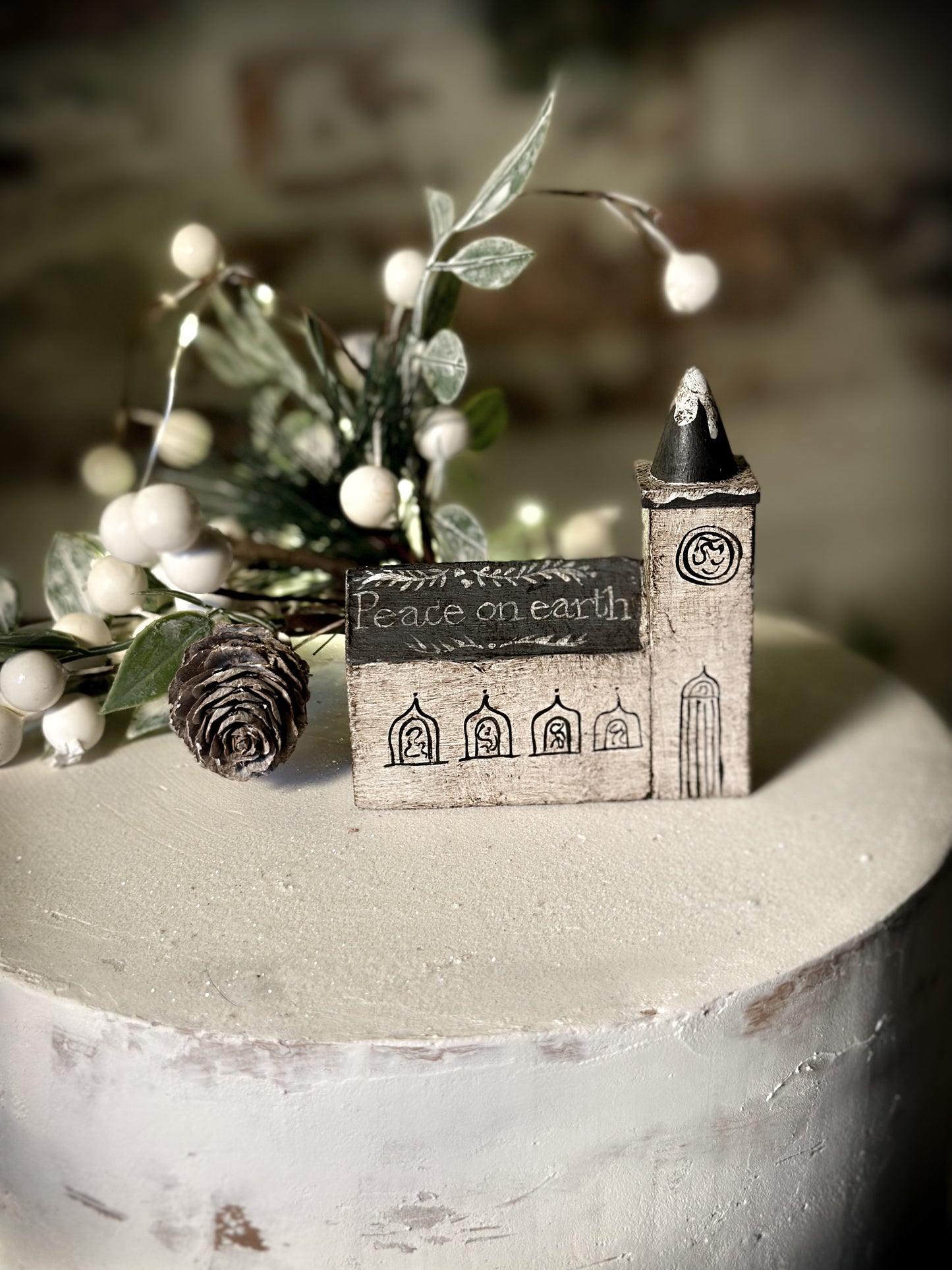 A pretty vintage German Erzgebirge Putz wooden village house painted with a Christmas quote