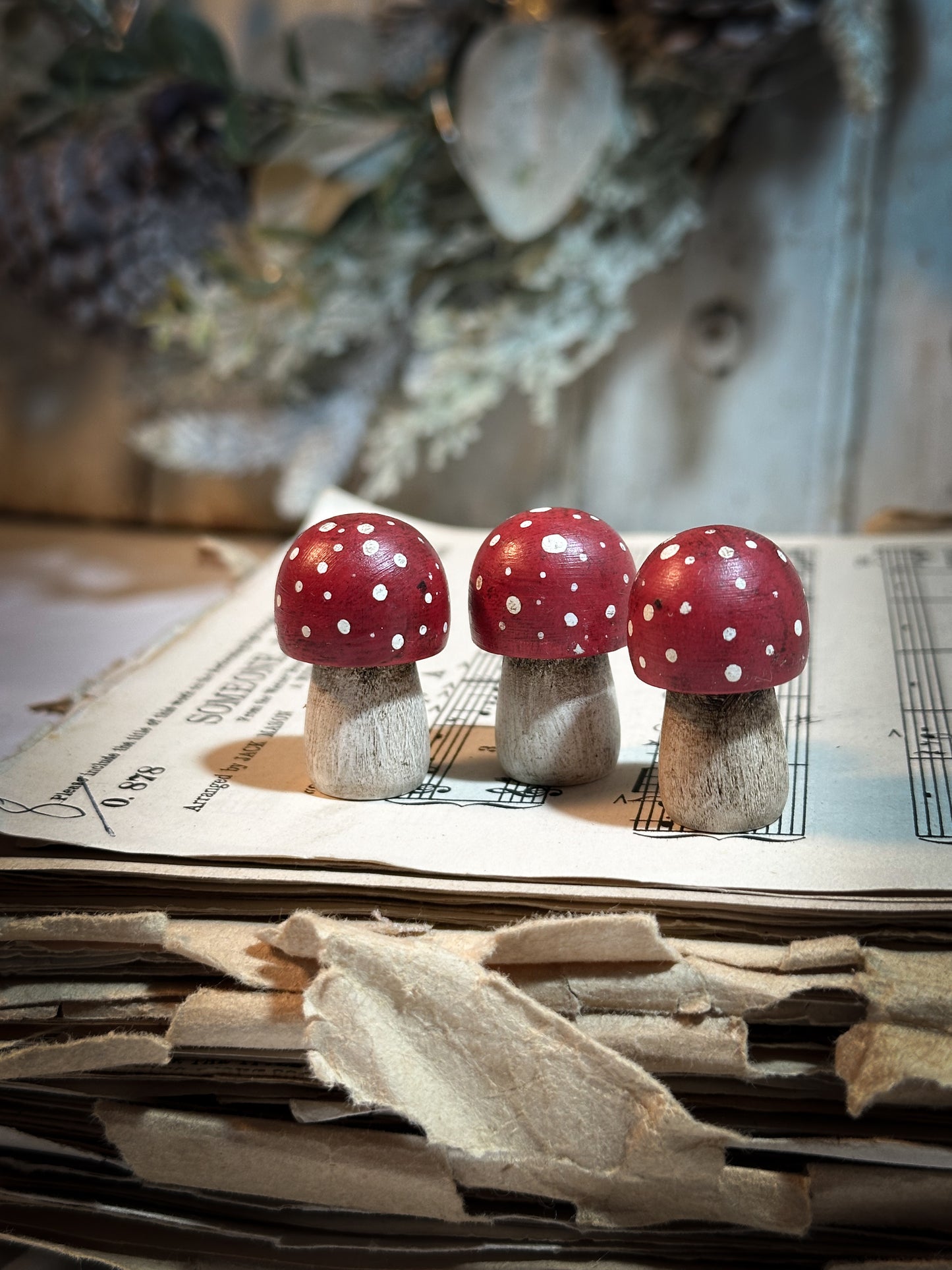 A wooden hand painted Christmas village toadstool