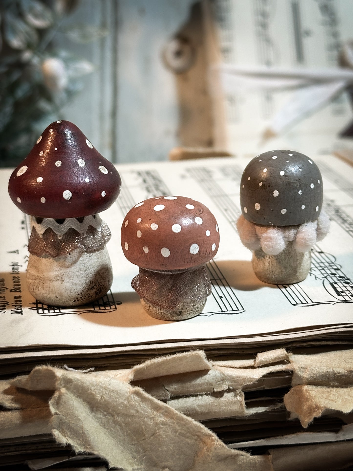 A set of three wooden hand painted and trimmed Christmas village toadstools