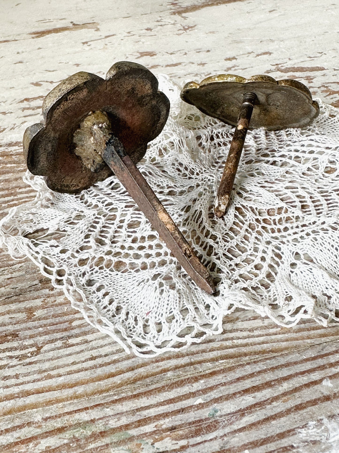A pair of antique brass salvaged French curtain tie back hooks