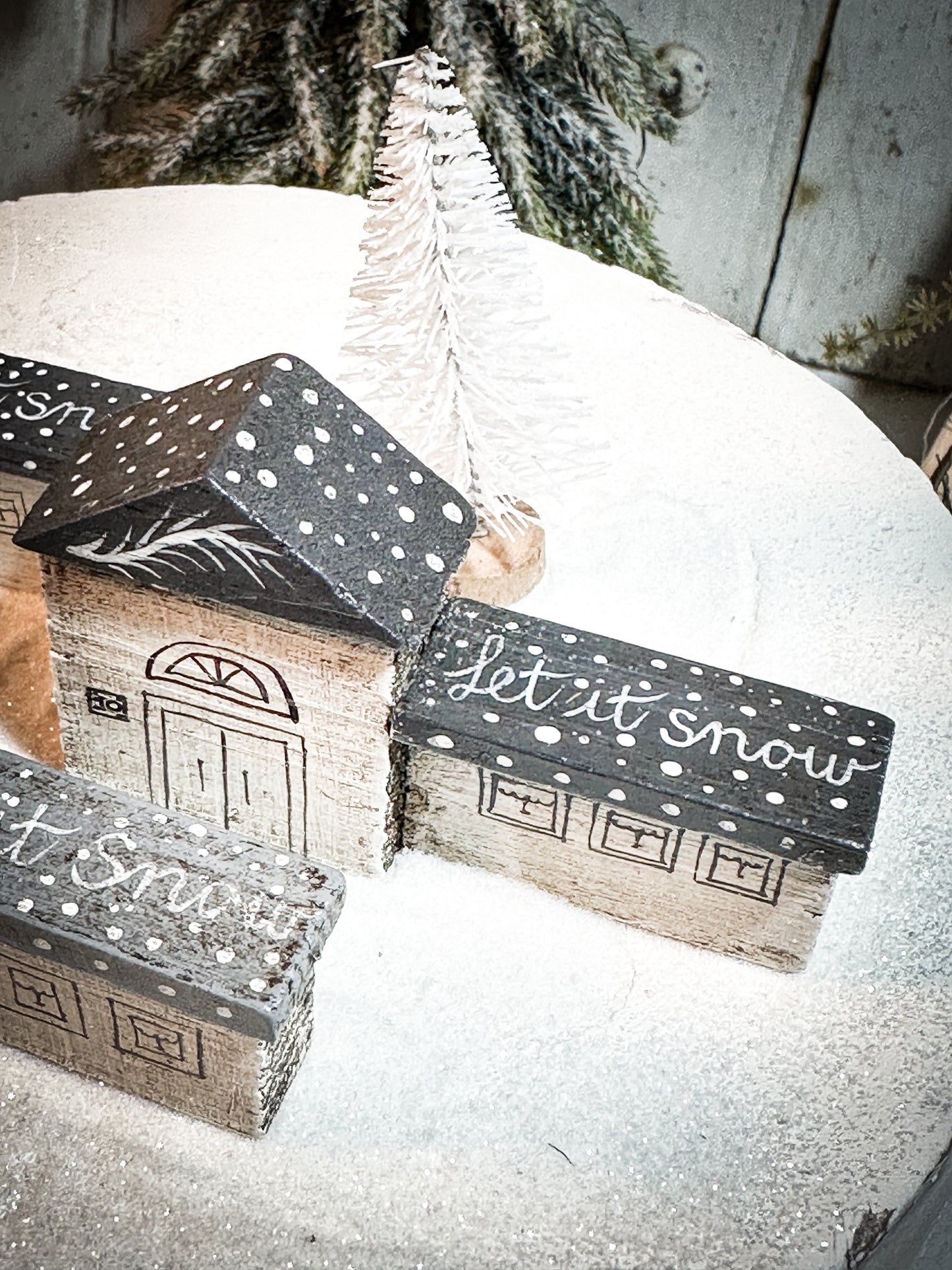 A pretty vintage German Erzgebirge Putz wooden village house painted with a Christmas quote