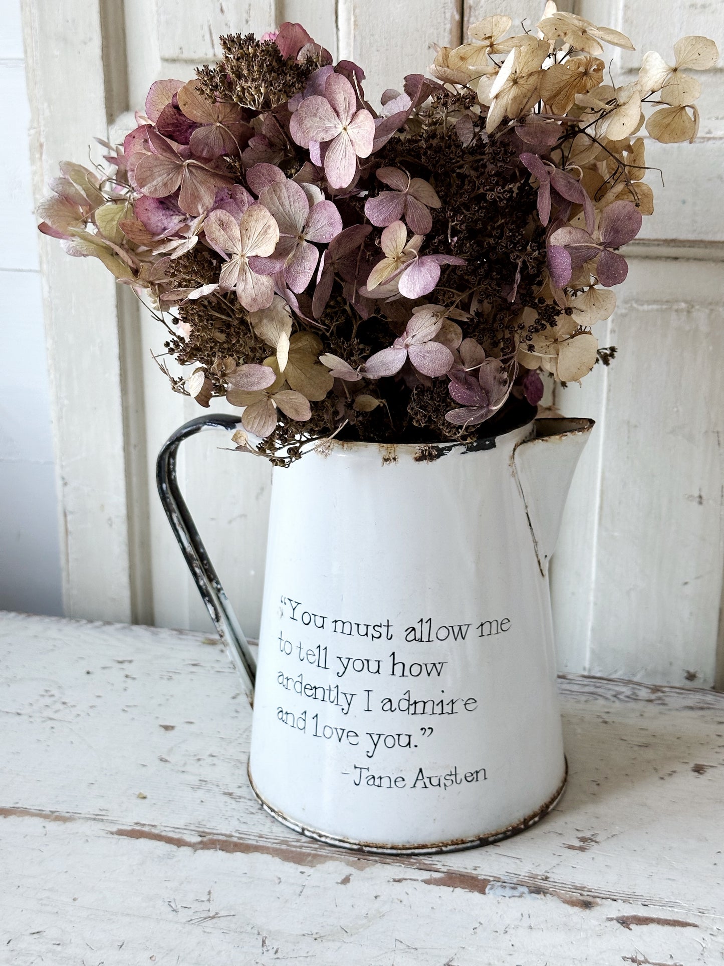 A hand painted quote on a beautiful Vintage white enamelware jug
