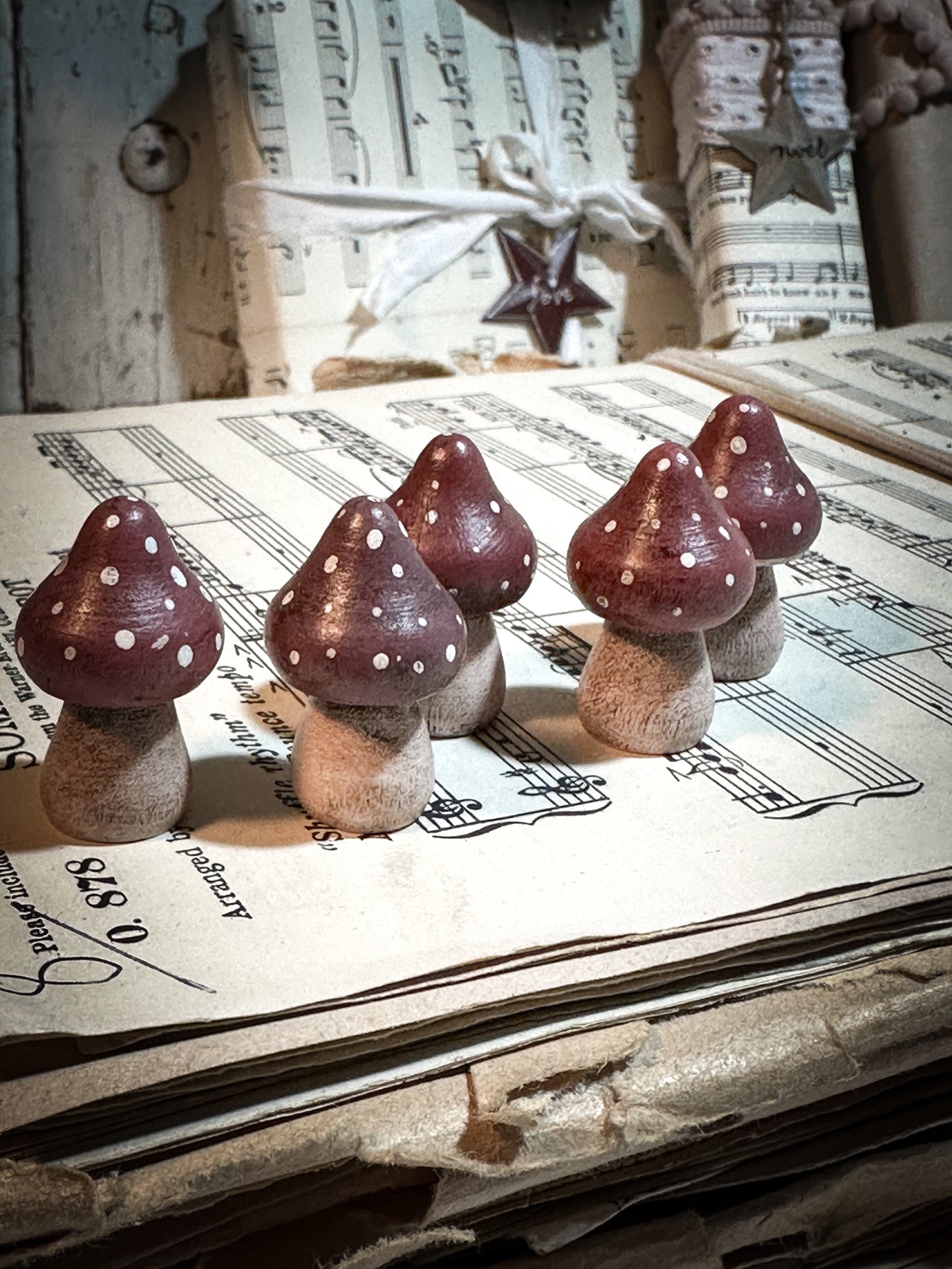 A wooden hand painted and trimmed Christmas village toadstool