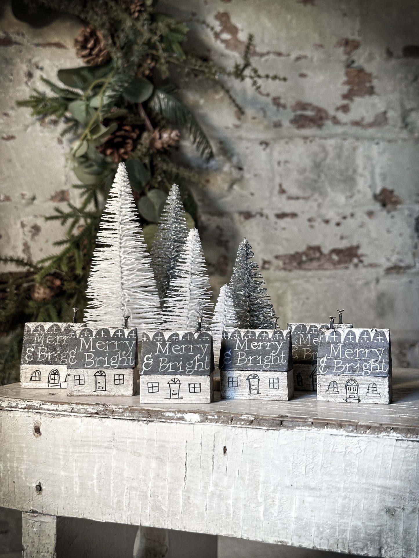 A pretty vintage German Erzgebirge Putz wooden village house painted with a Christmas quote
