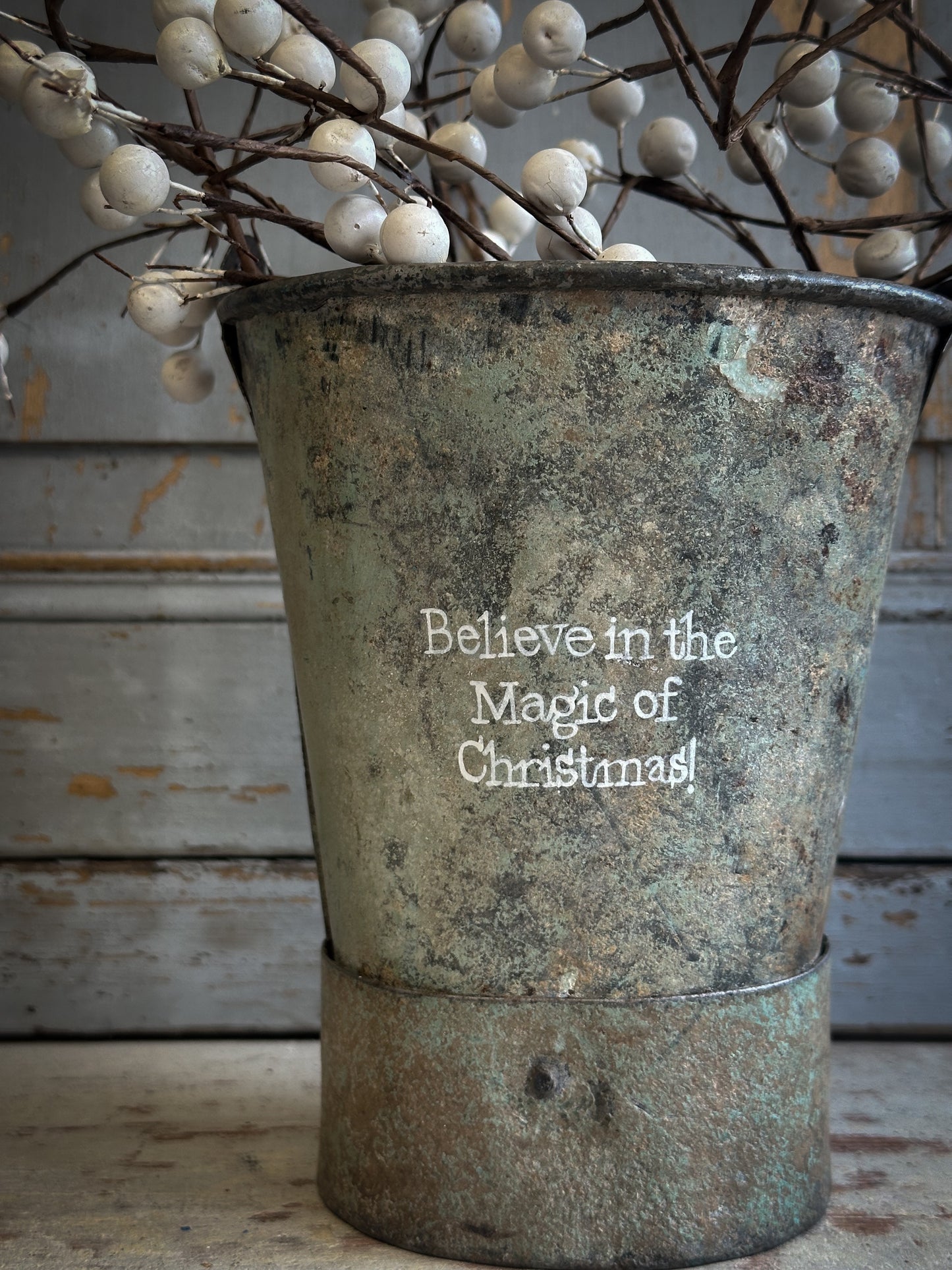 A Recycled Metal Mini Christmas Tree Bucket With A Hand Painted Quote