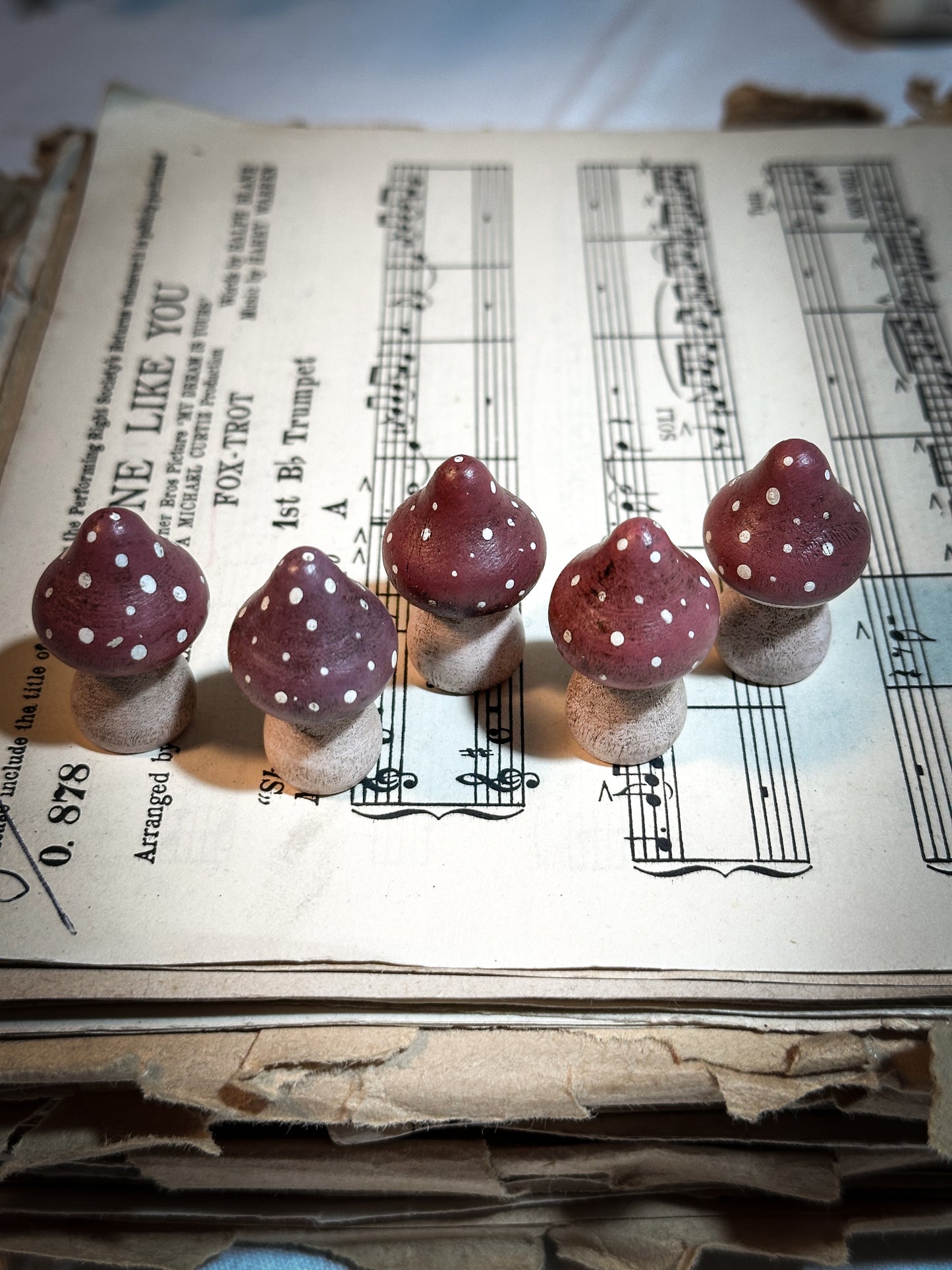 A wooden hand painted and trimmed Christmas village toadstool