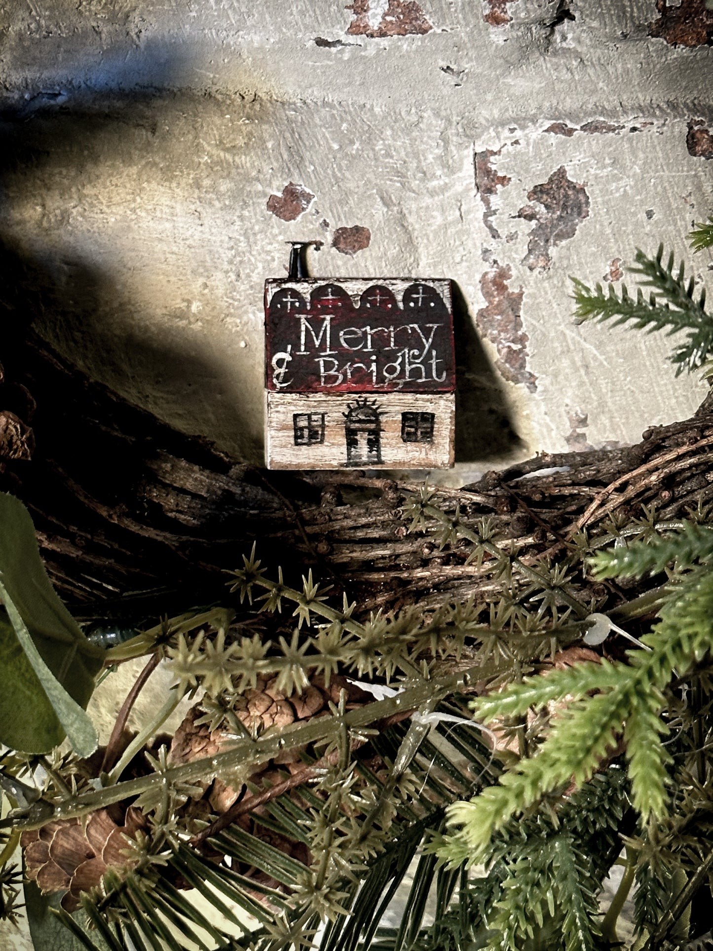 A pretty vintage German Erzgebirge Putz wooden village house painted with a Christmas quote