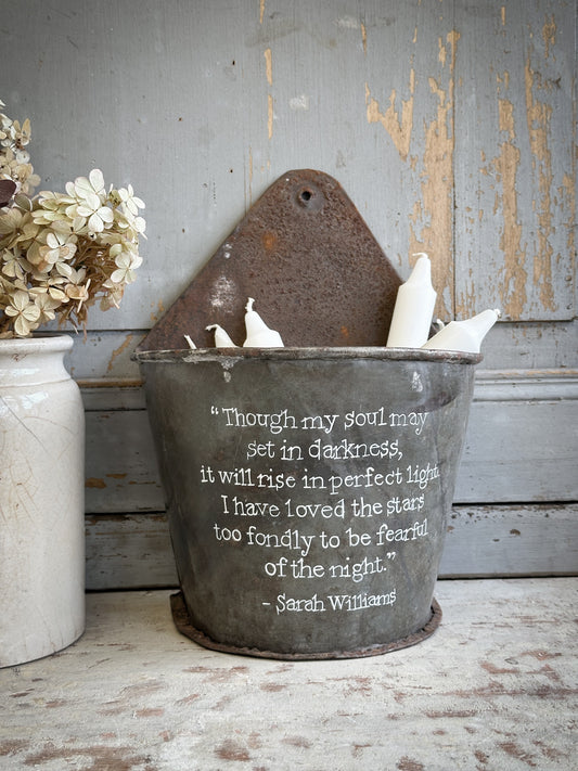 A Recycled Metal Candle Store With A Hand Painted Quote
